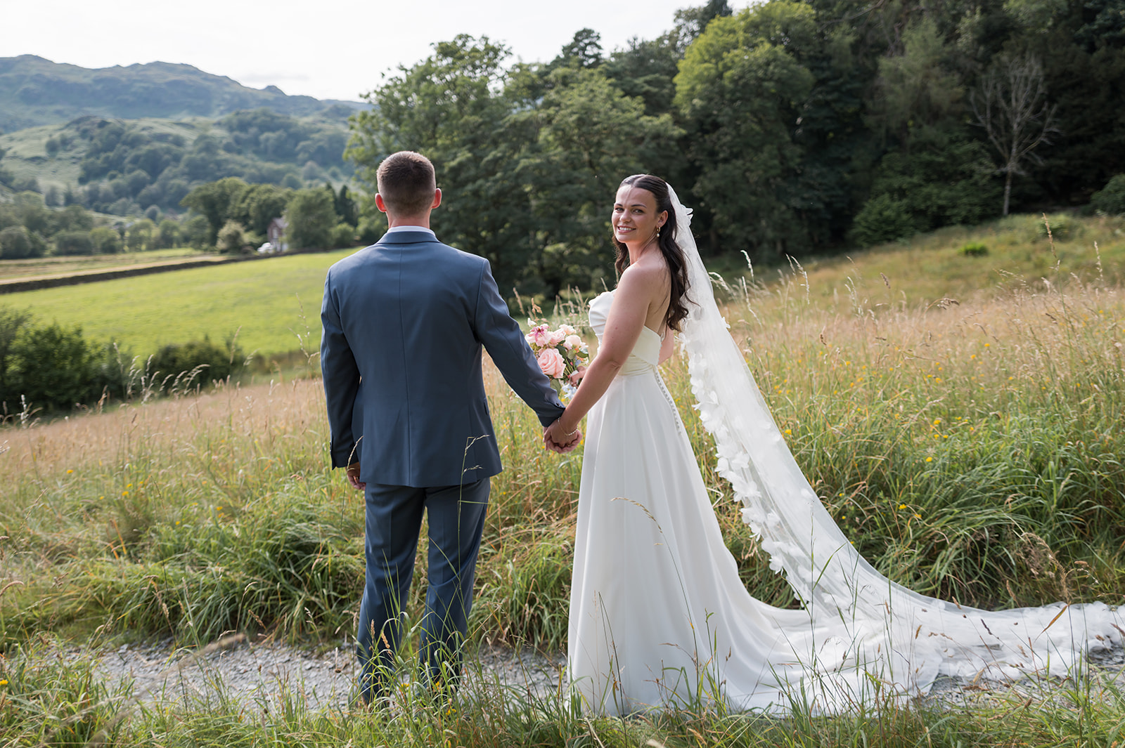 Alex and Dan in the meadow overlooking the Lake District at Lancrigg