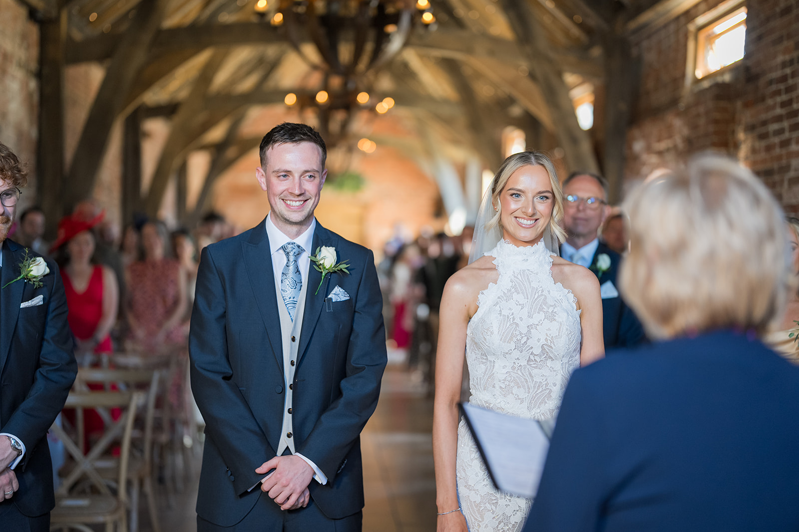 Emma and Jack smiling during their ceremony at Grangefields