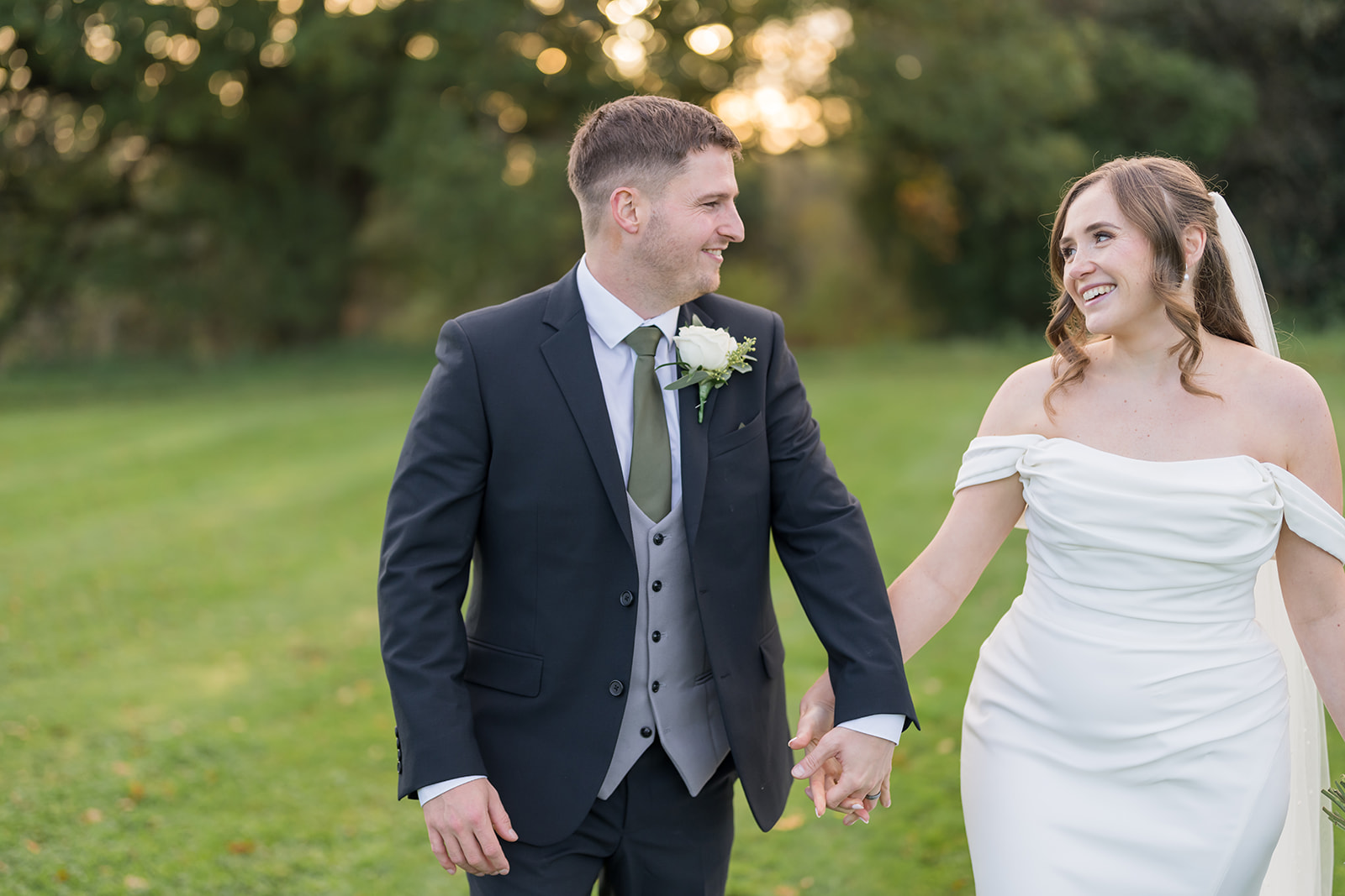 Harriet and Gareth walking hand in hand in the grounds at Hyde Bank Farm