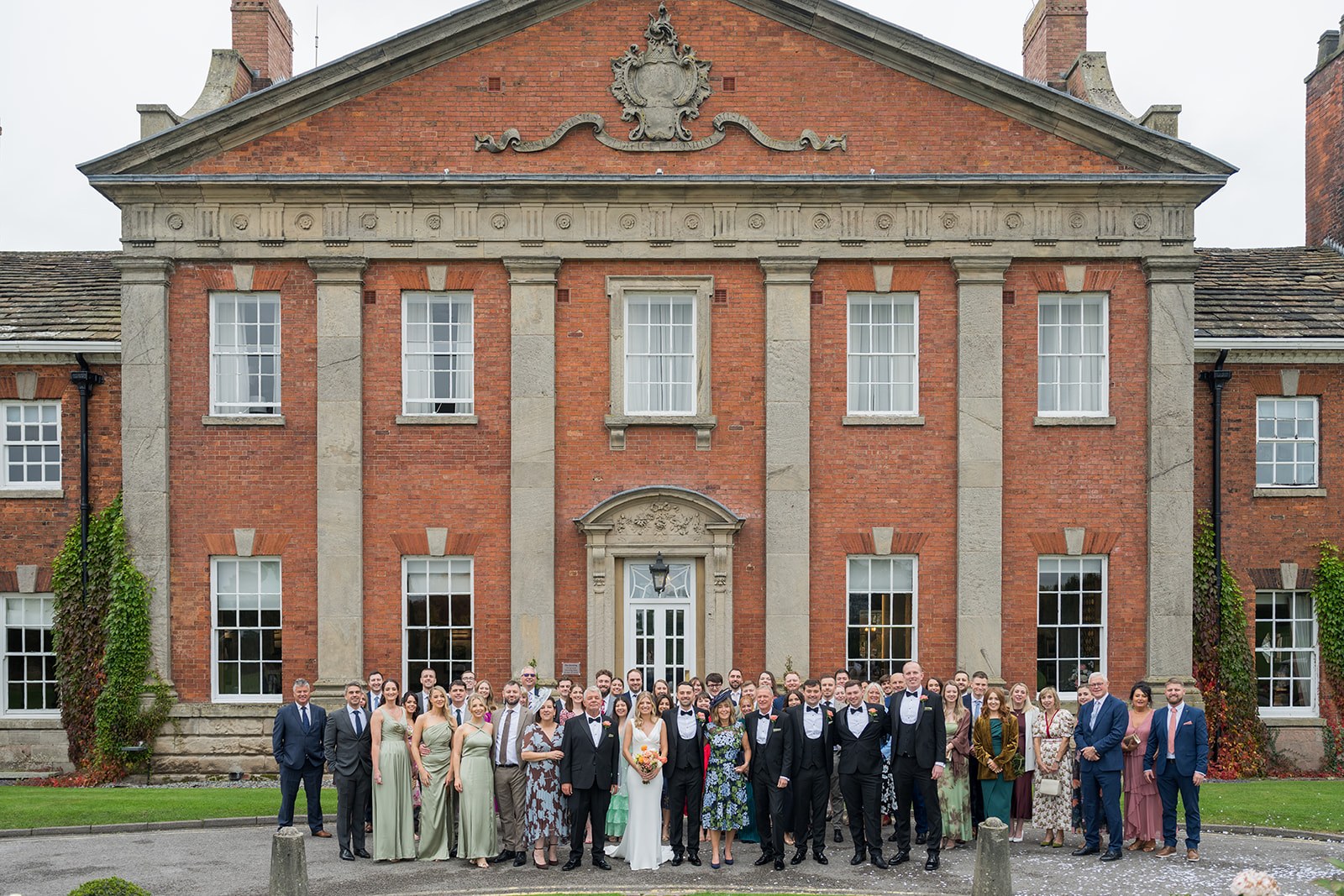 Family and friends in front of the hall at Mottram Hall