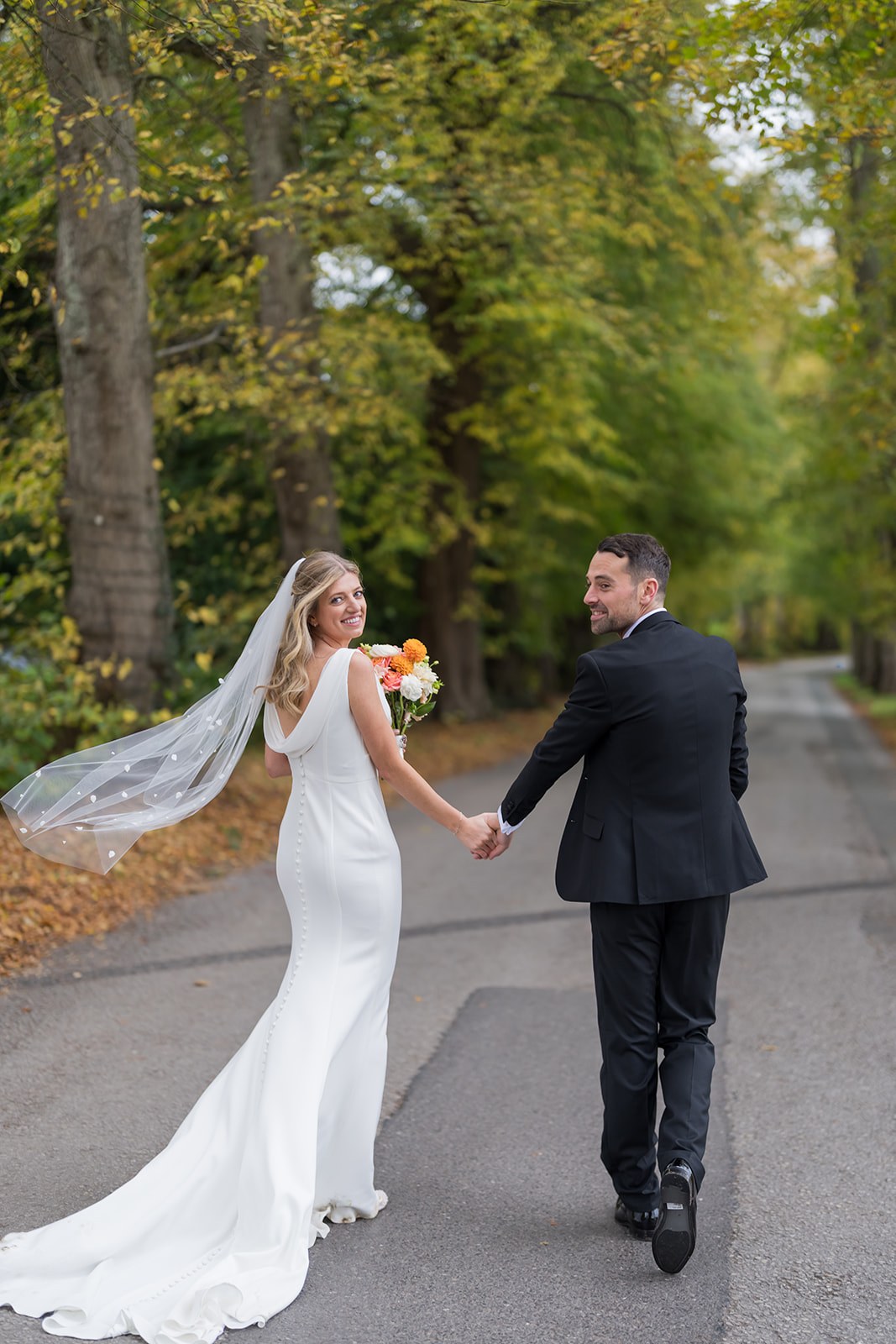 Walking along the tree-lined drive at Mottram Hall