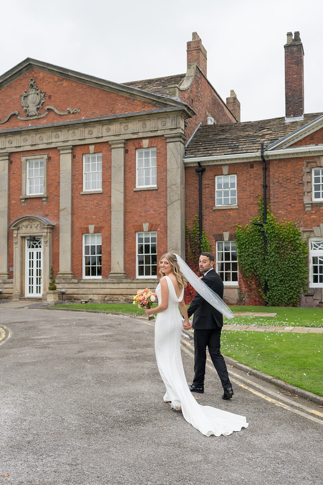 Amy and Daniel outside the hall at Mottram Hall