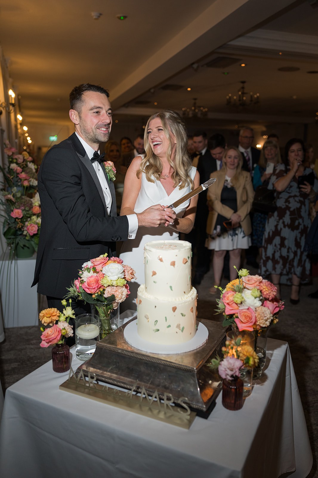 Cutting the wedding cake at Mottram Hall