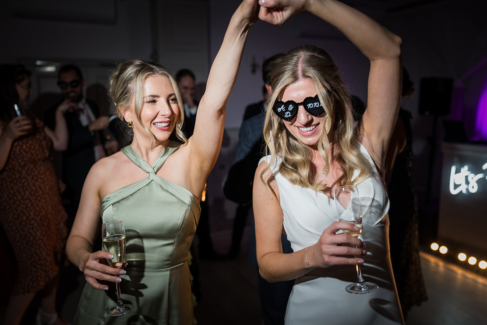 Friends celebrating on the dance floor at Mottram Hall
