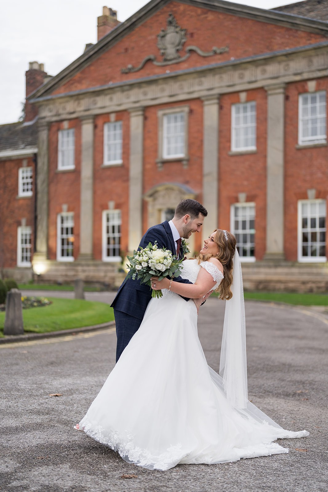 A portrait against the hall’s red-brick frontage at Mottram Hall