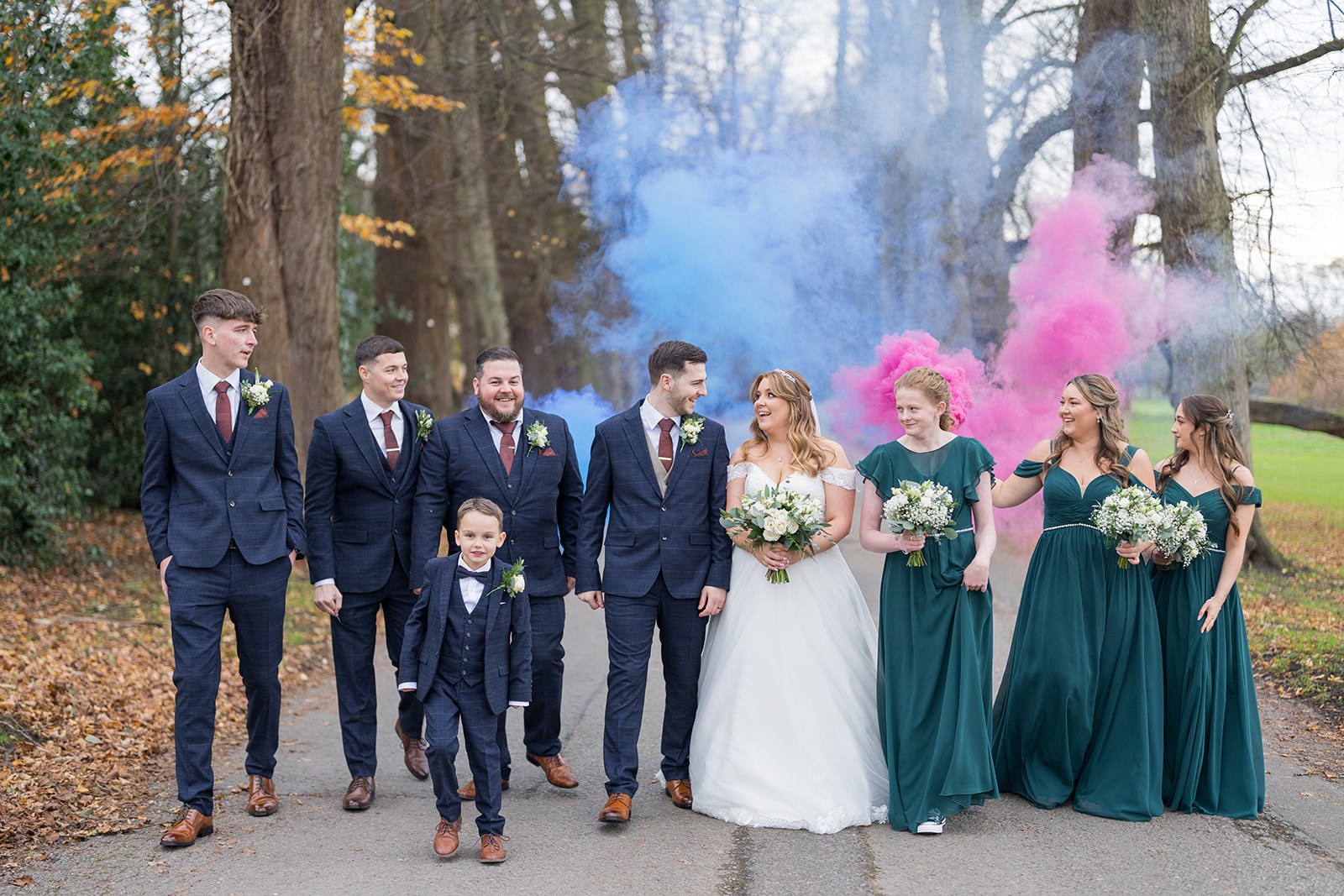 The wedding party on the tree-lined drive at Mottram Hall