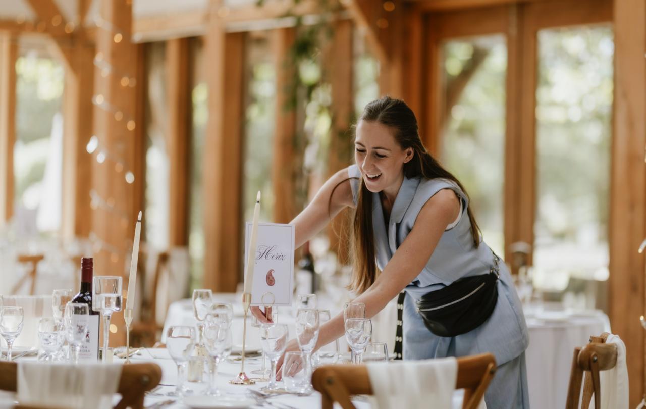 Natalie of Perfect Day Weddings arranging a wedding reception table