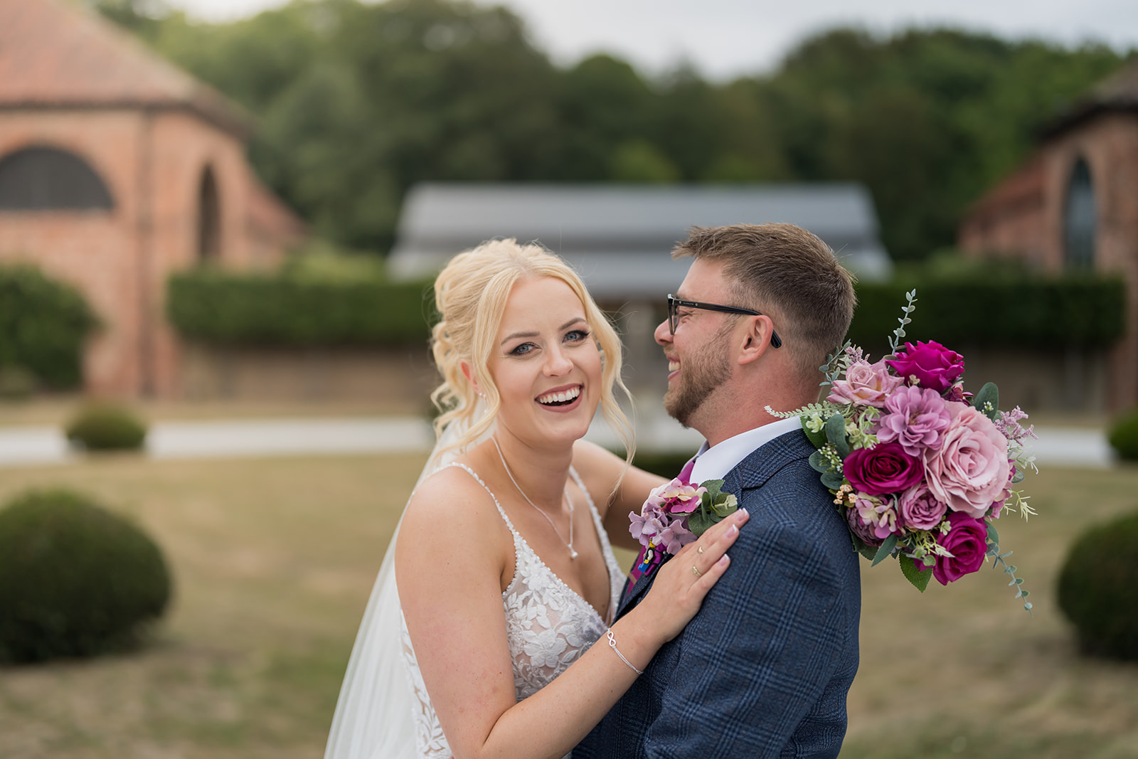 Bride and groom laughing together outside their wedding venue
