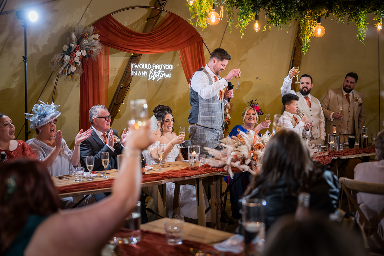 Guests enjoying the speeches at a wedding reception