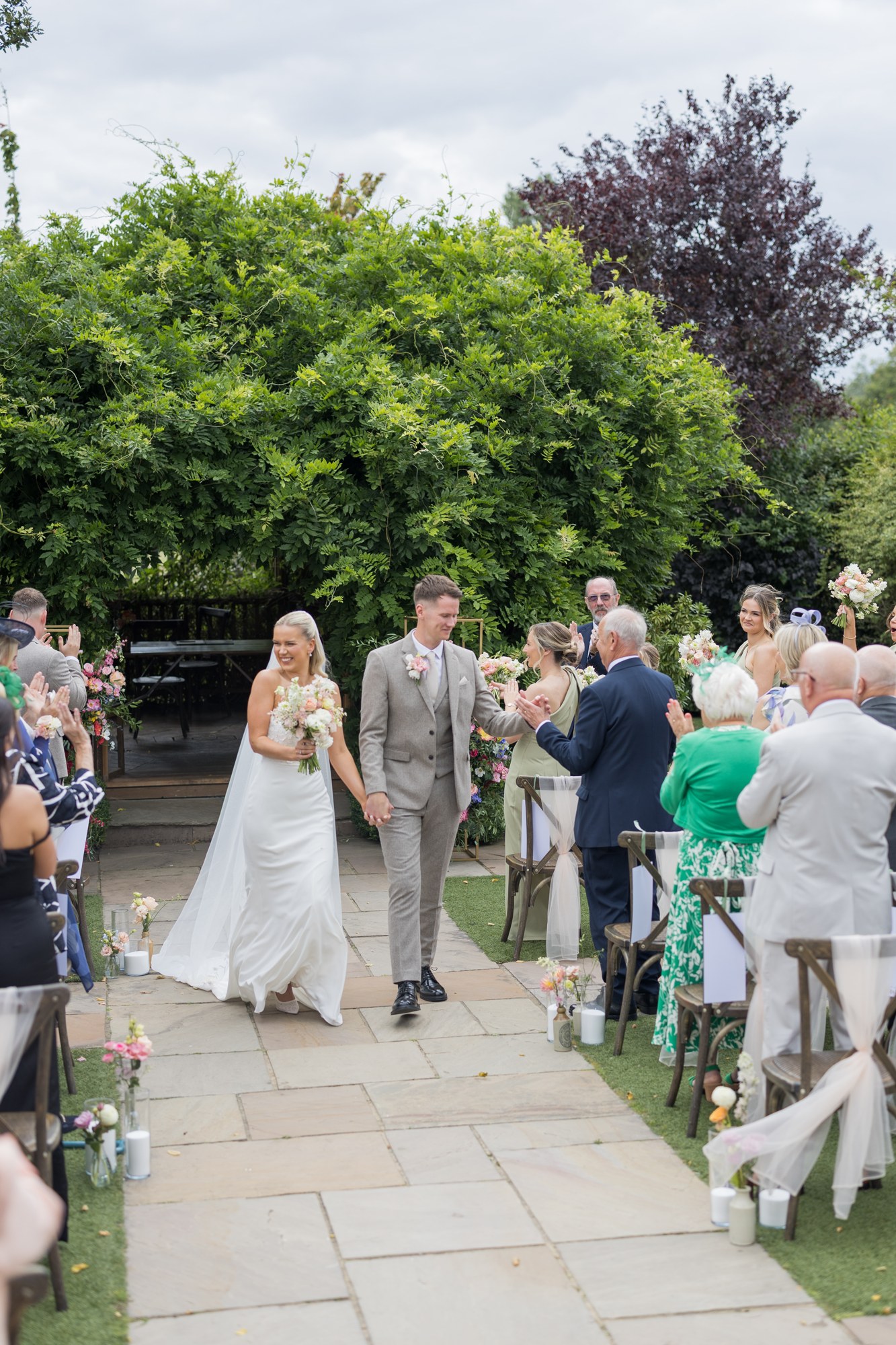 Walking back through the outdoor ceremony at Pryors Hayes