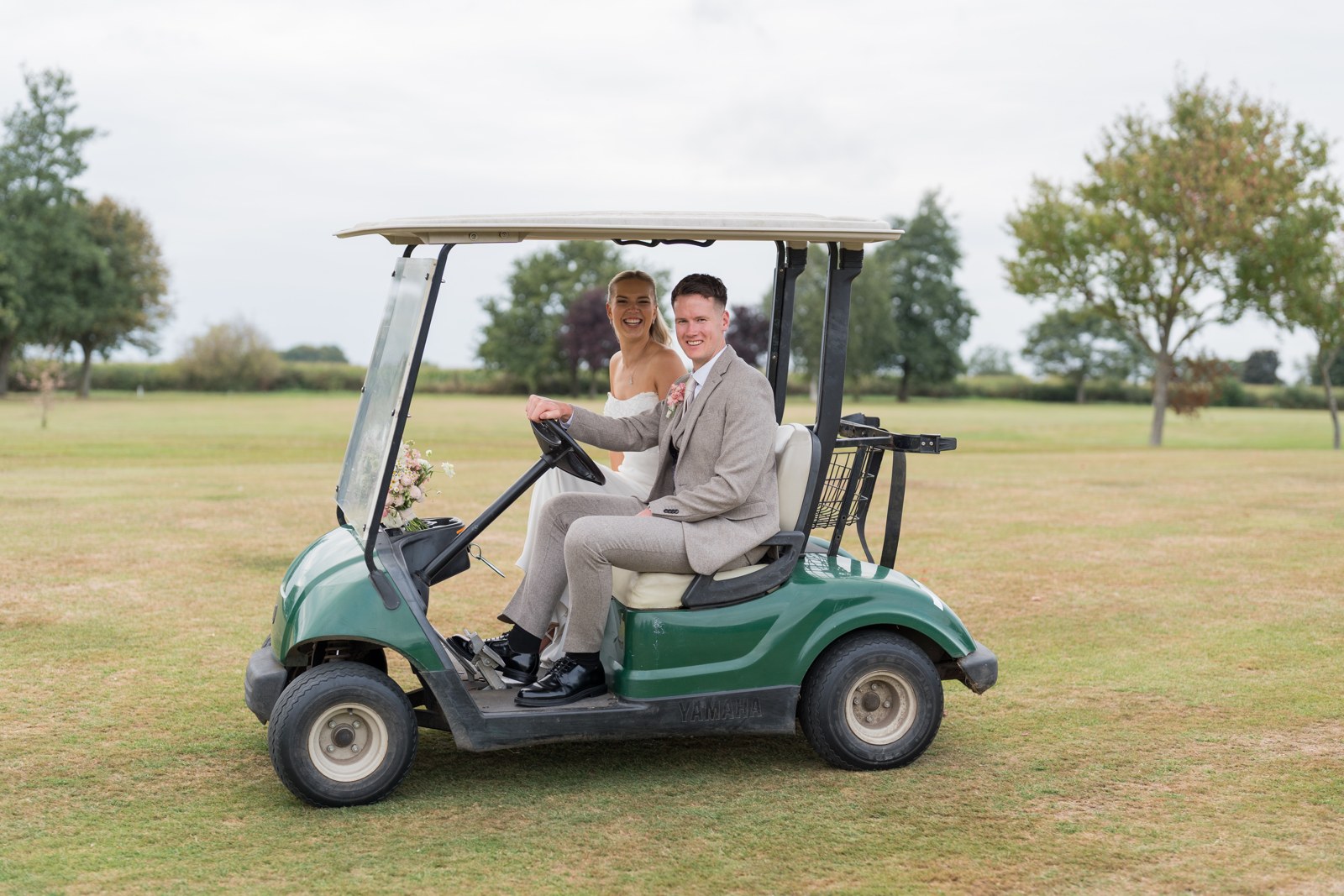 Harry and Jenny in a golf buggy at Pryors Hayes