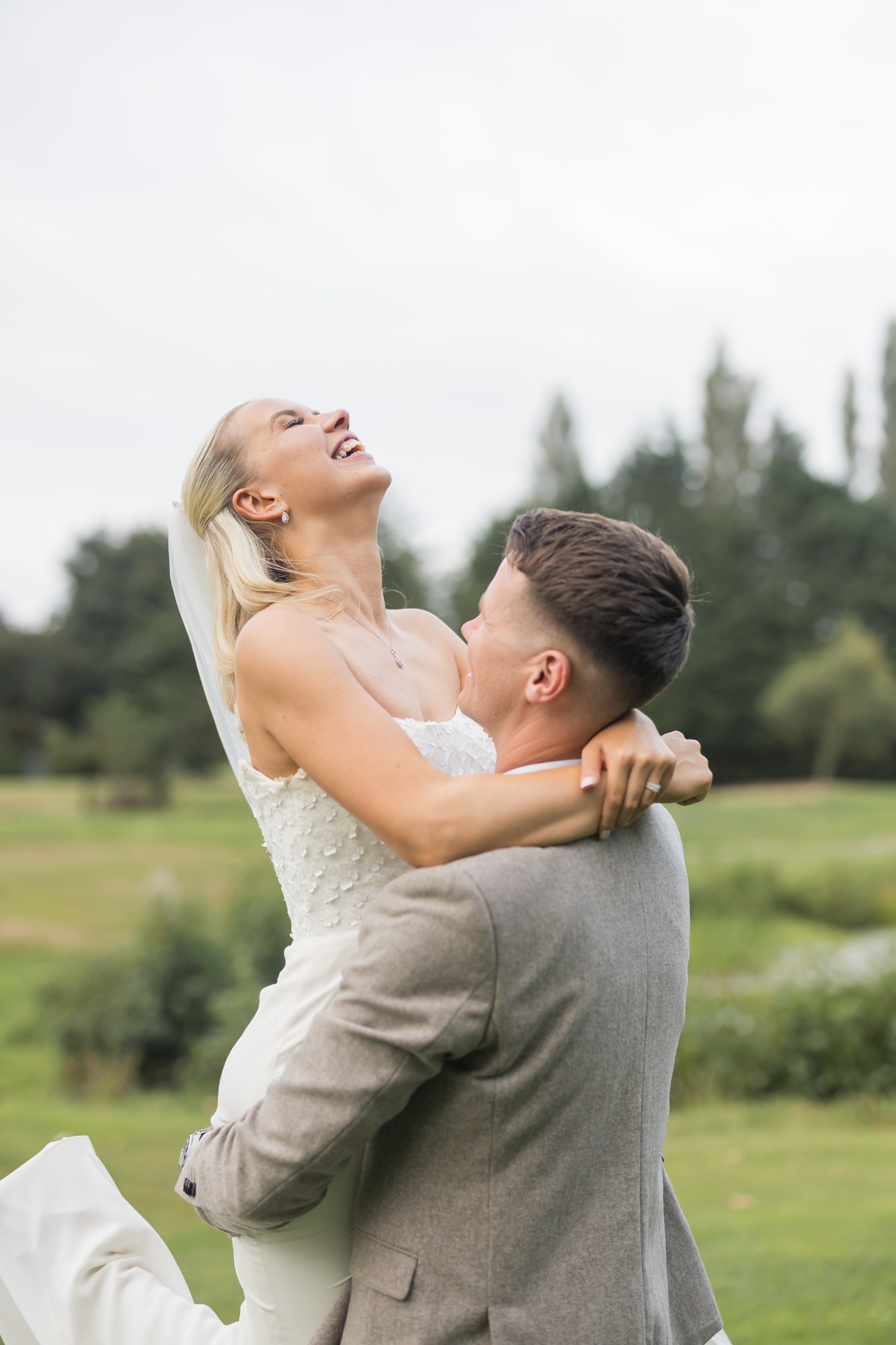 Harry lifting Jenny during their portraits at Pryors Hayes
