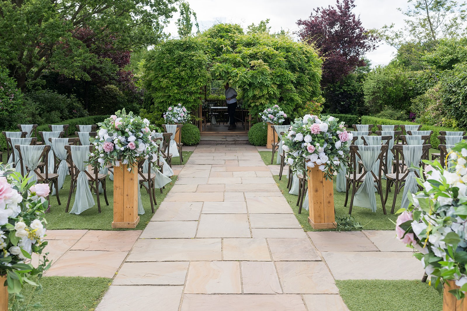 The outdoor ceremony aisle dressed with flowers at Pryors Hayes