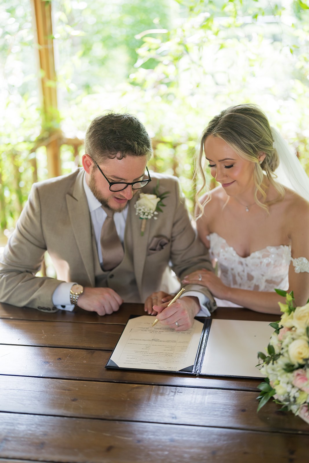 Signing the register in the garden pavilion at Pryors Hayes