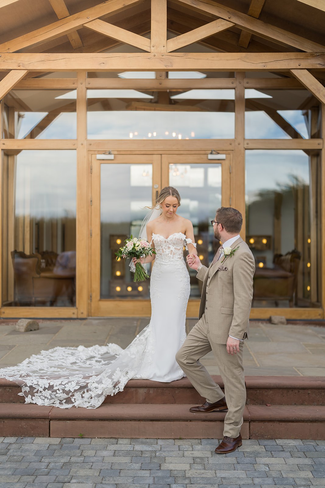 Kayleigh and Ryan outside the timber-framed entrance at Pryors Hayes