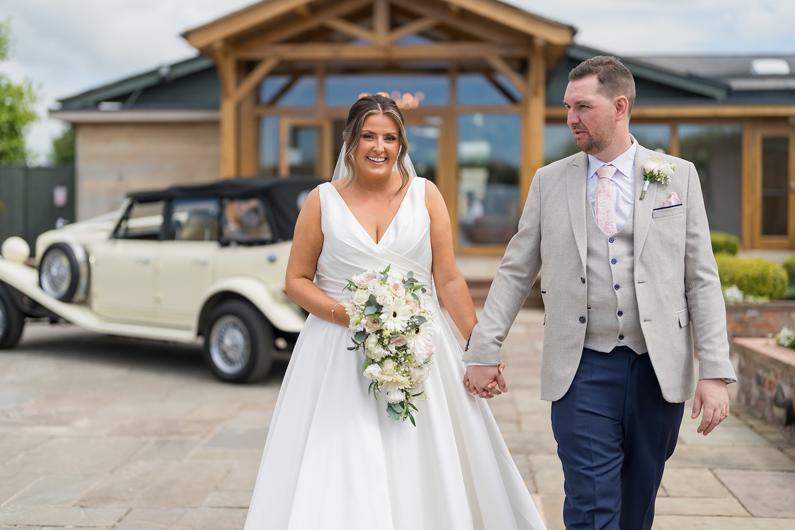Mollie and Mark outside the reception entrance at Pryors Hayes