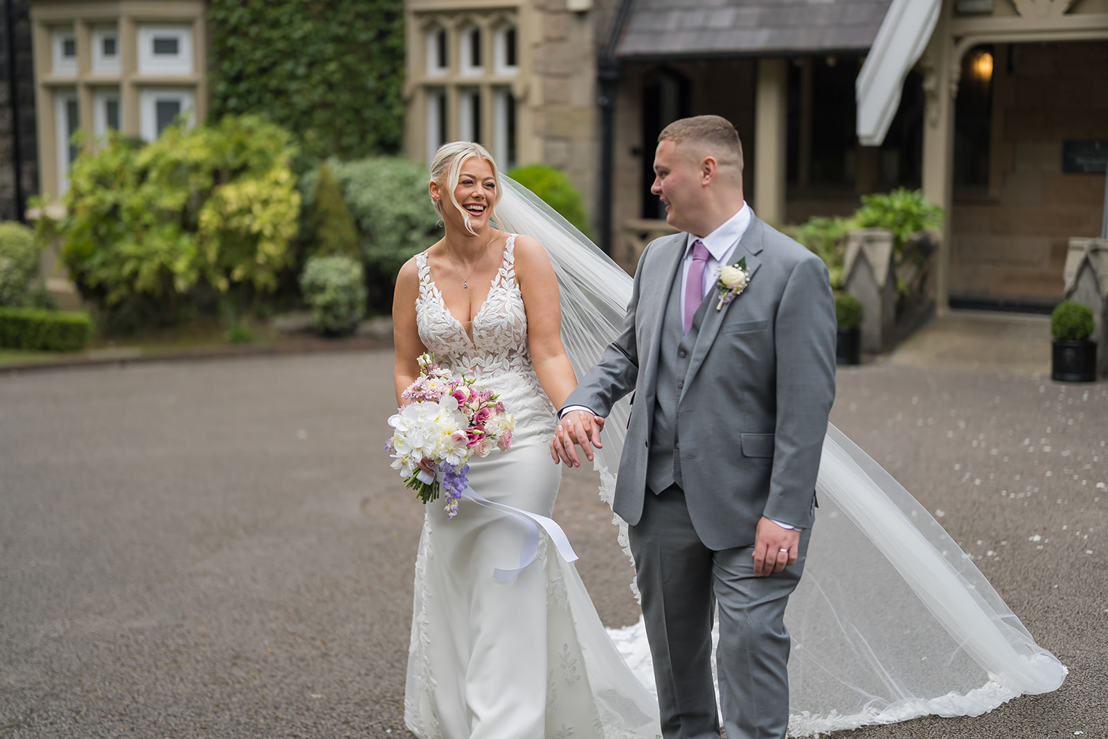 Samantha and Adam laughing together outside West Tower in Aughton