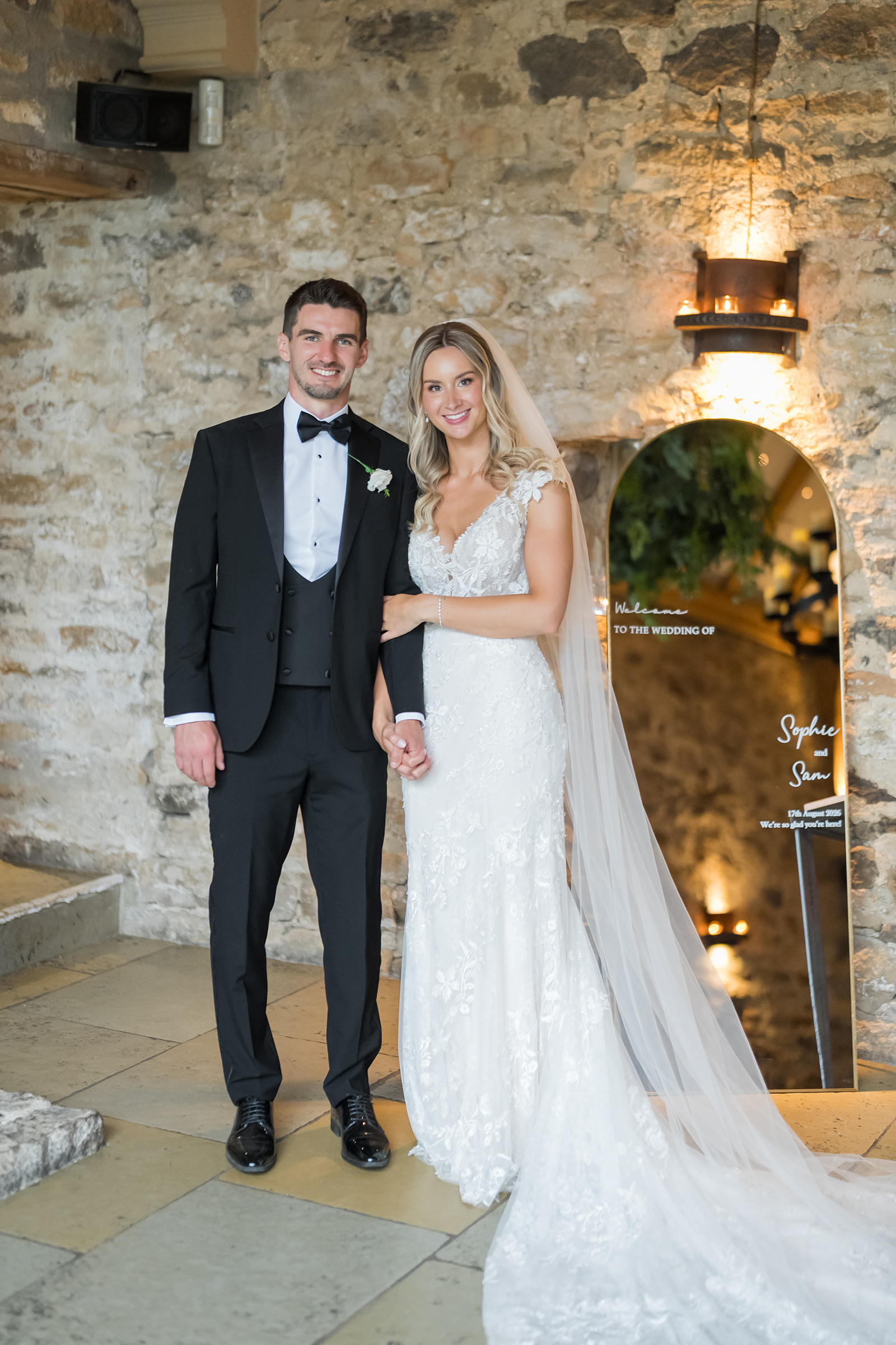 Sophie and Sam beside the stone wall at Healey Barn in Northumberland