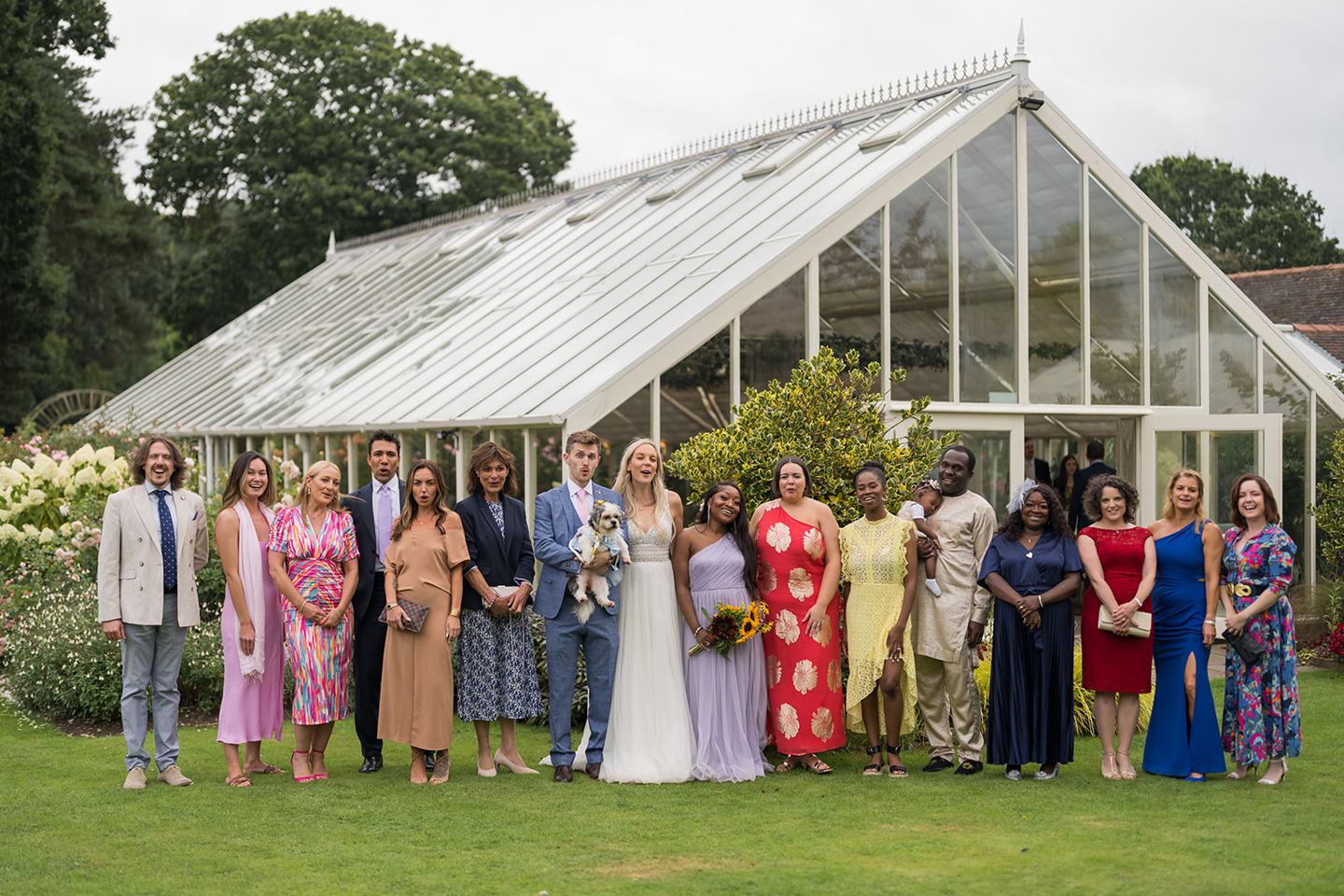 Wedding guests outside the glasshouse at Annie and Joe’s Abbeywood Estate wedding