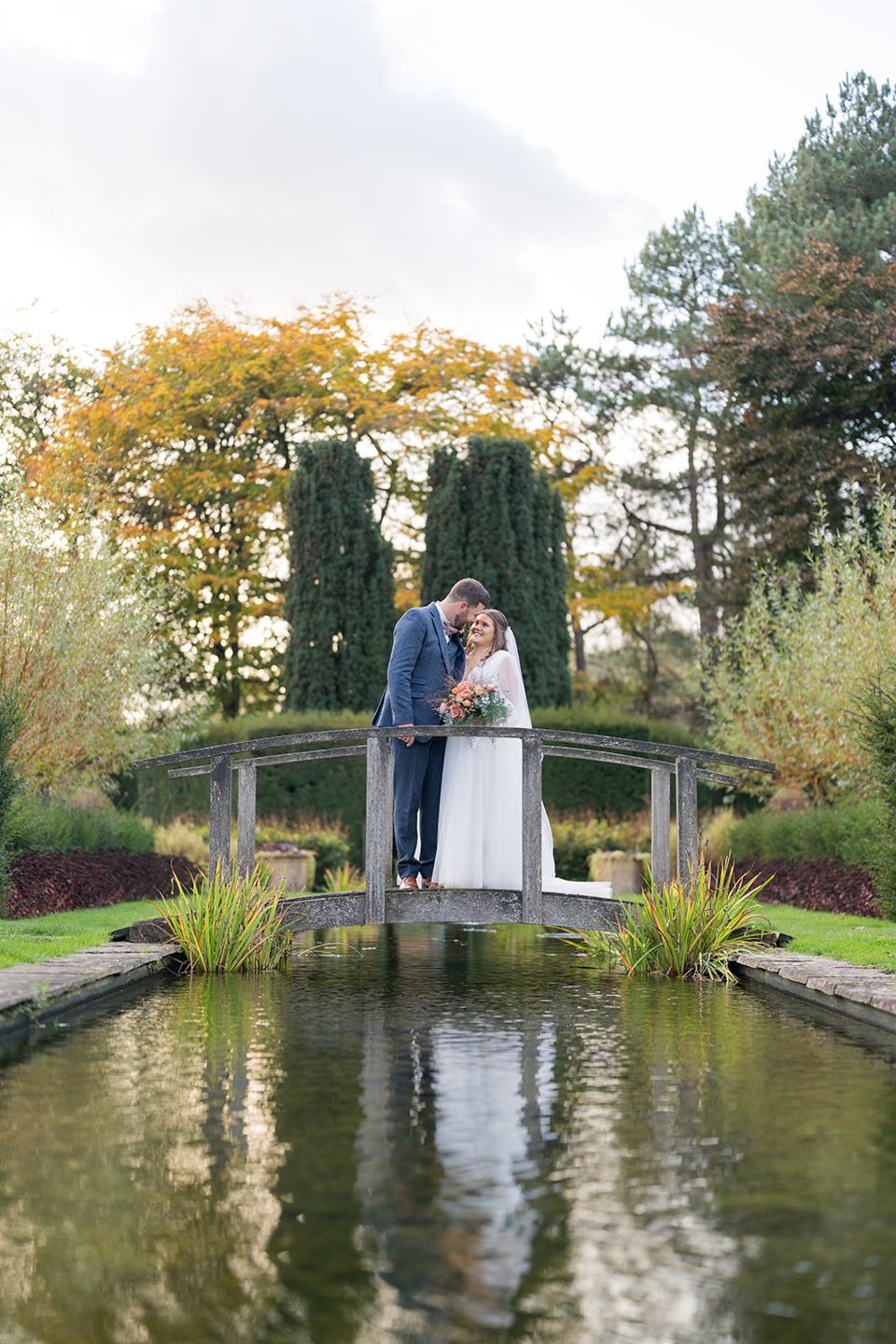 Reflections beside the garden bridge at Gemma and James’s Abbeywood Estate wedding