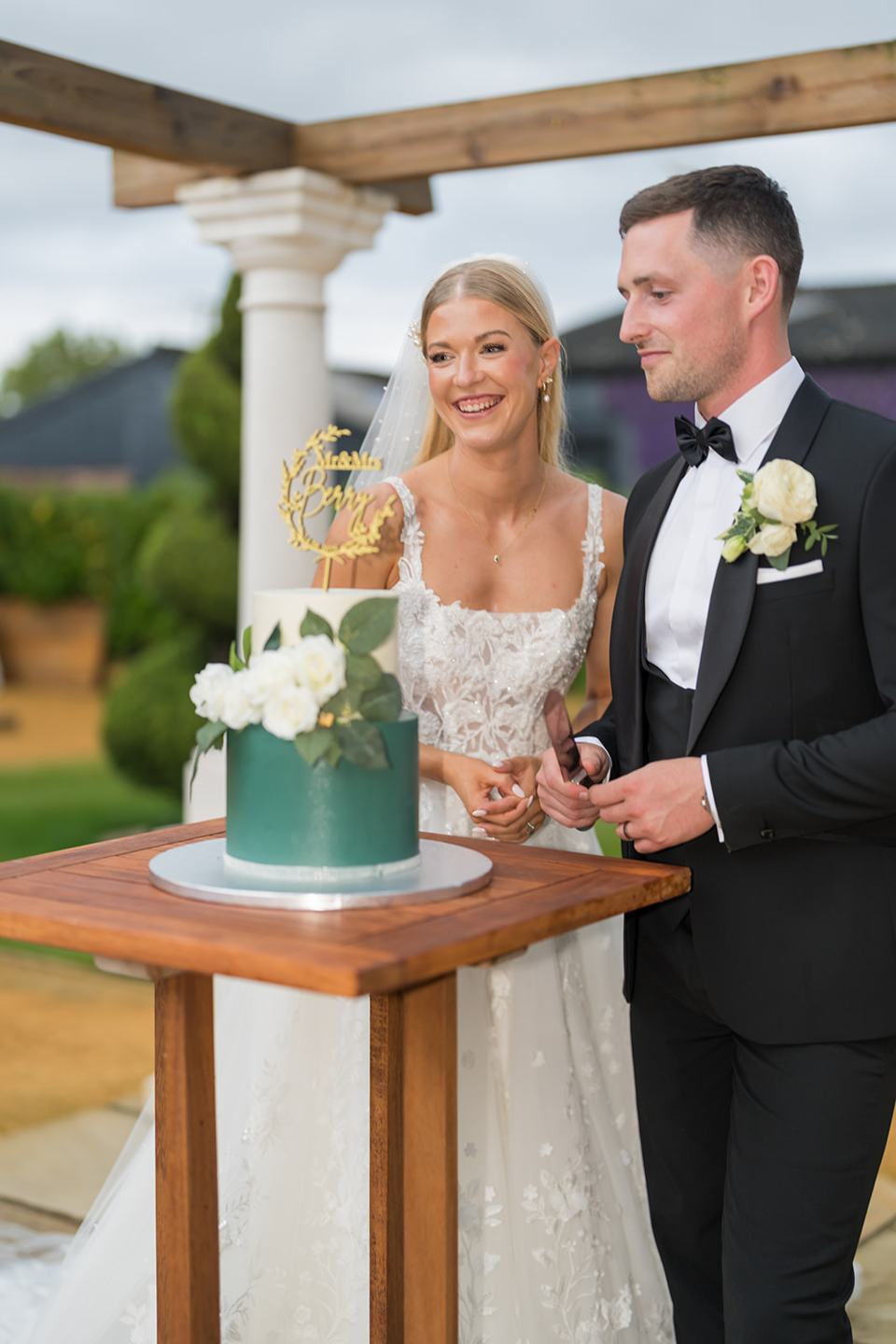 Cutting the wedding cake at Evie and Josh’s Burlton Manor wedding