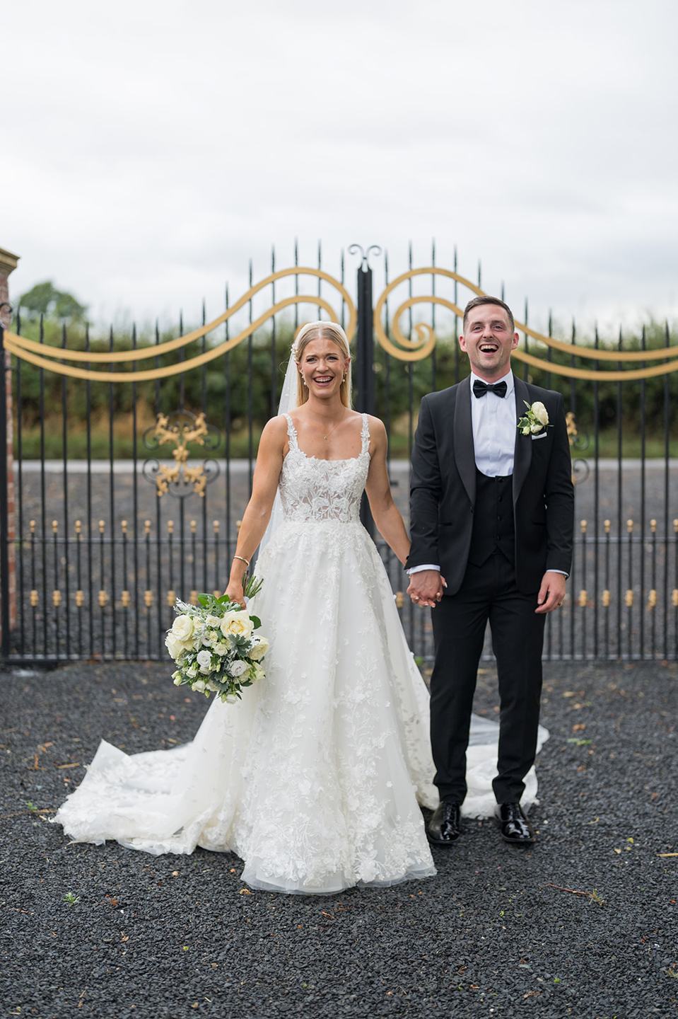 Portrait at the manor gates at Evie and Josh’s Burlton Manor wedding