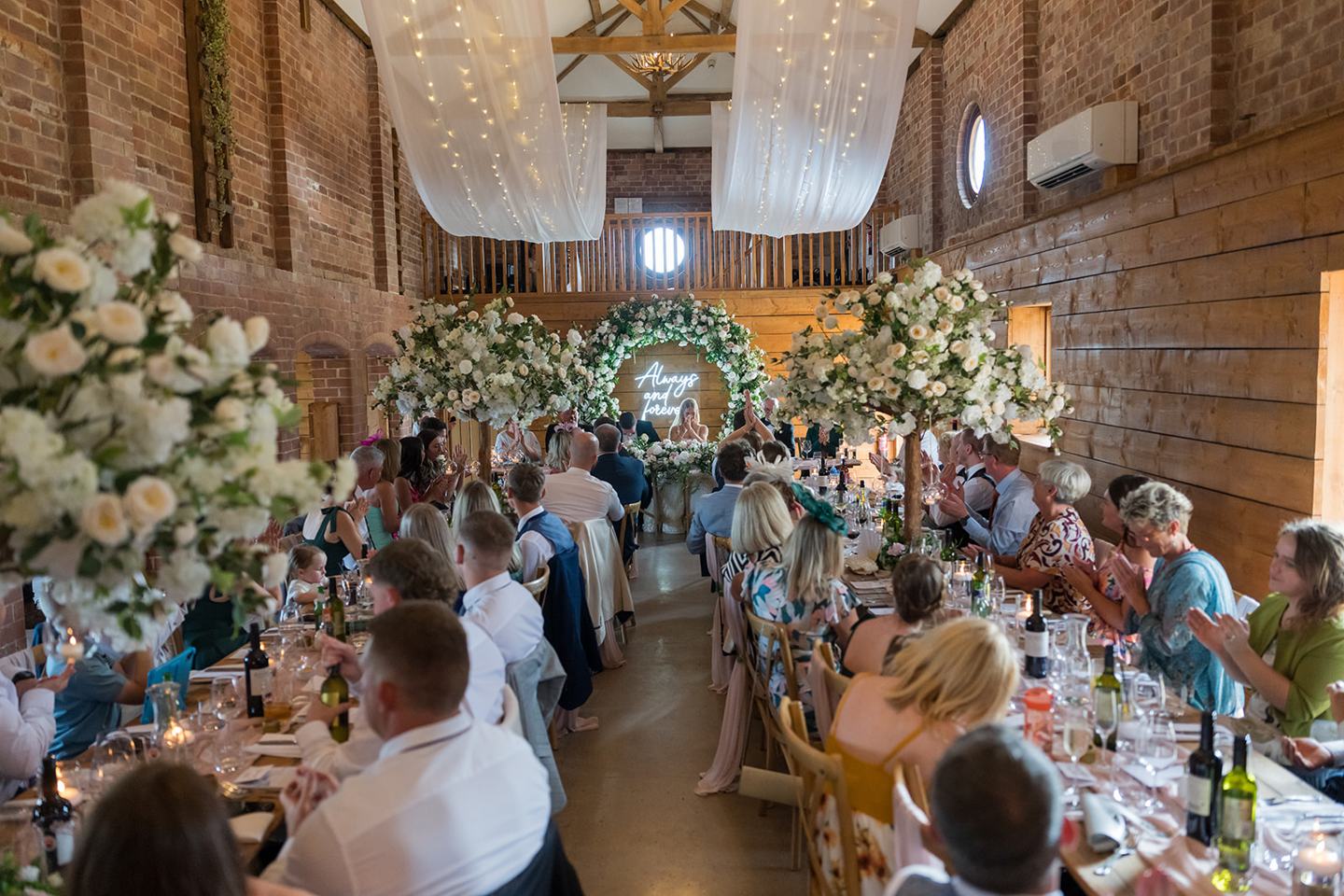 Wedding breakfast in the barn at Evie and Josh’s Burlton Manor wedding