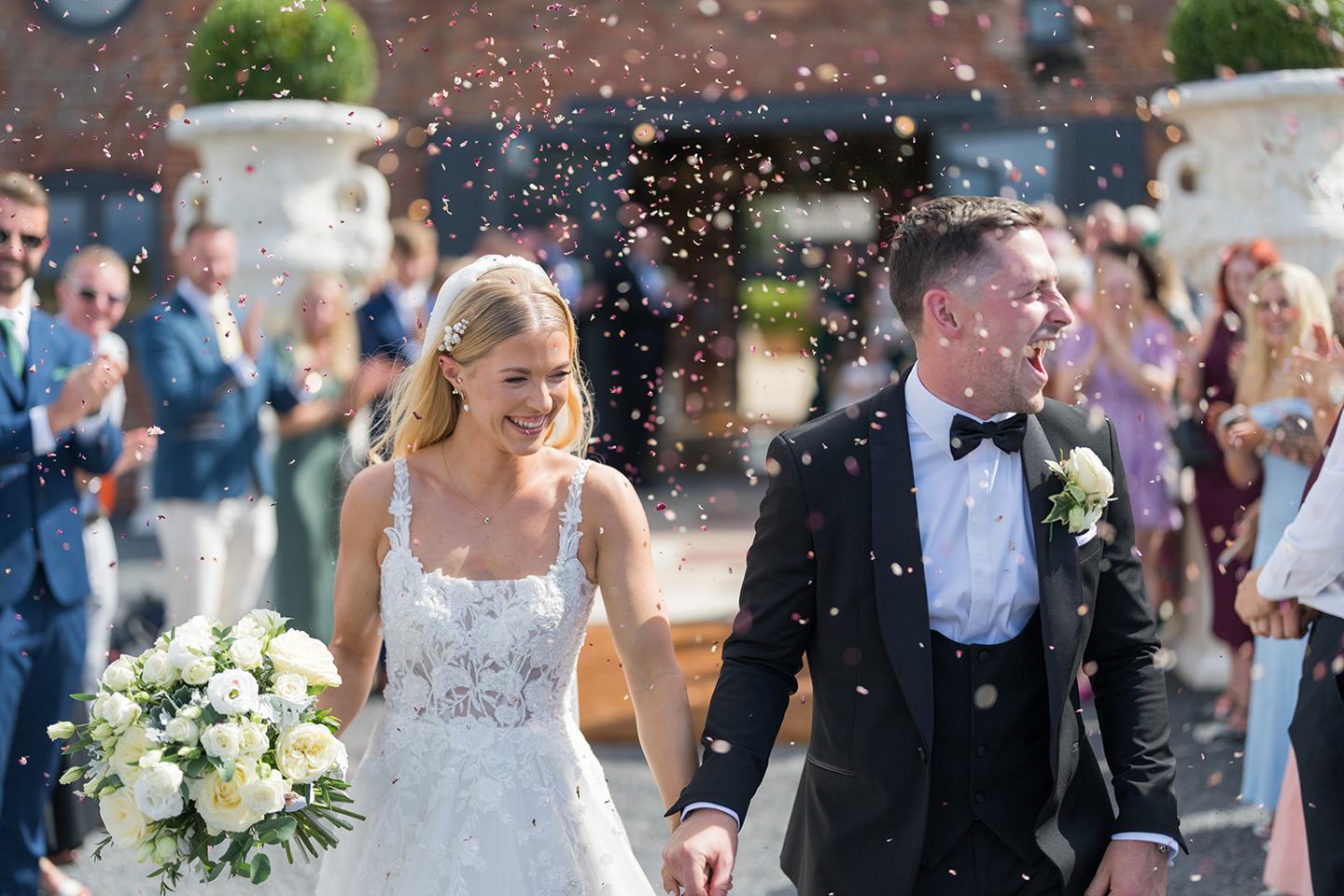 Confetti in the courtyard at Evie and Josh’s Burlton Manor wedding