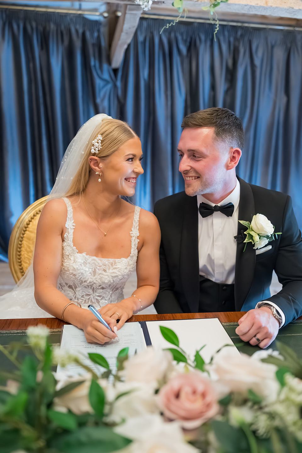 Signing the register at Evie and Josh’s Burlton Manor wedding