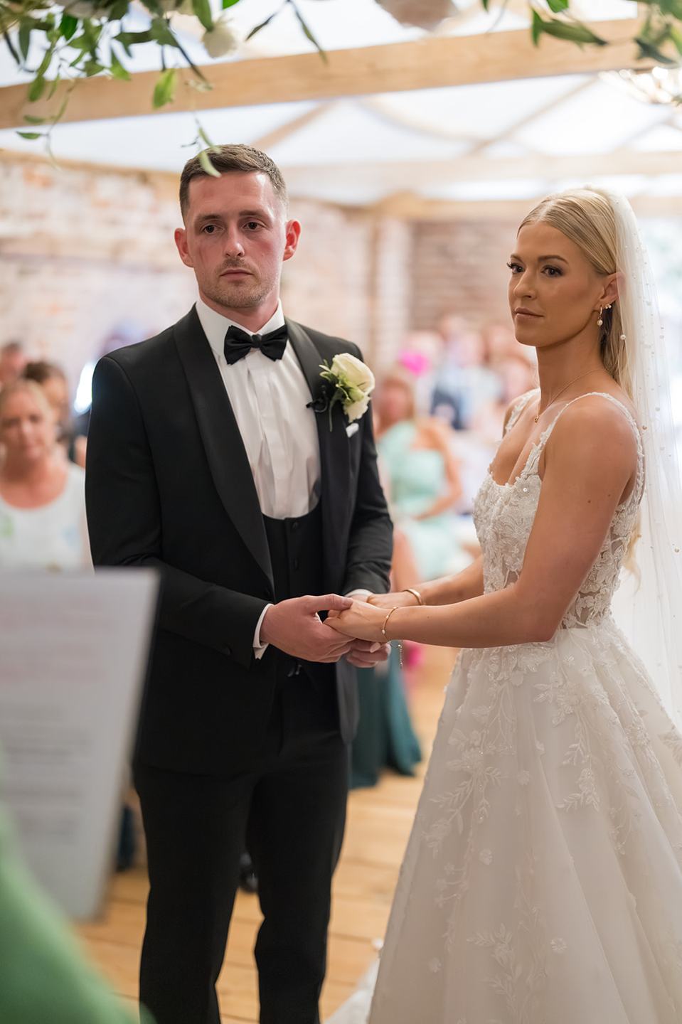 Couple during the ceremony at Evie and Josh’s Burlton Manor wedding