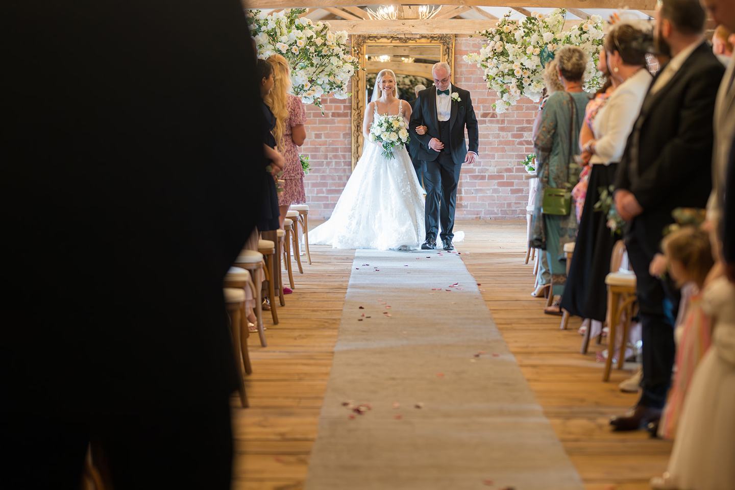 Bride arriving for the ceremony at Evie and Josh’s Burlton Manor wedding