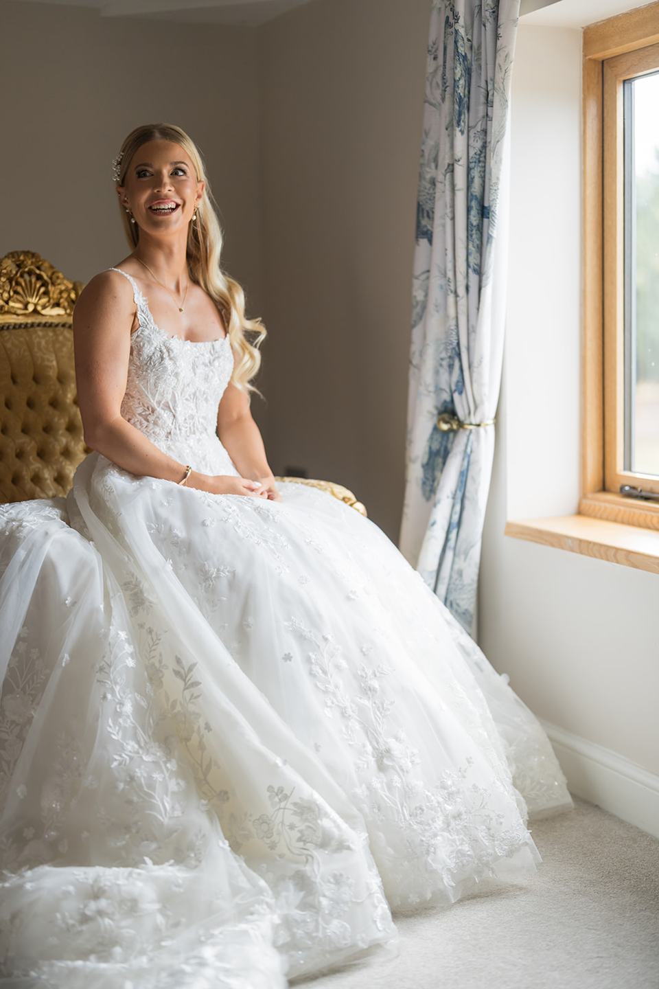 Bridal portrait by the window at Evie and Josh’s Burlton Manor wedding