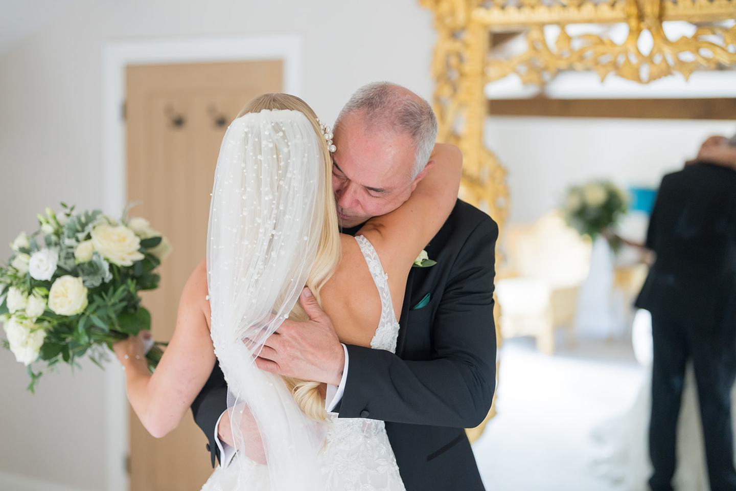 Bride greeting her father at Evie and Josh’s Burlton Manor wedding