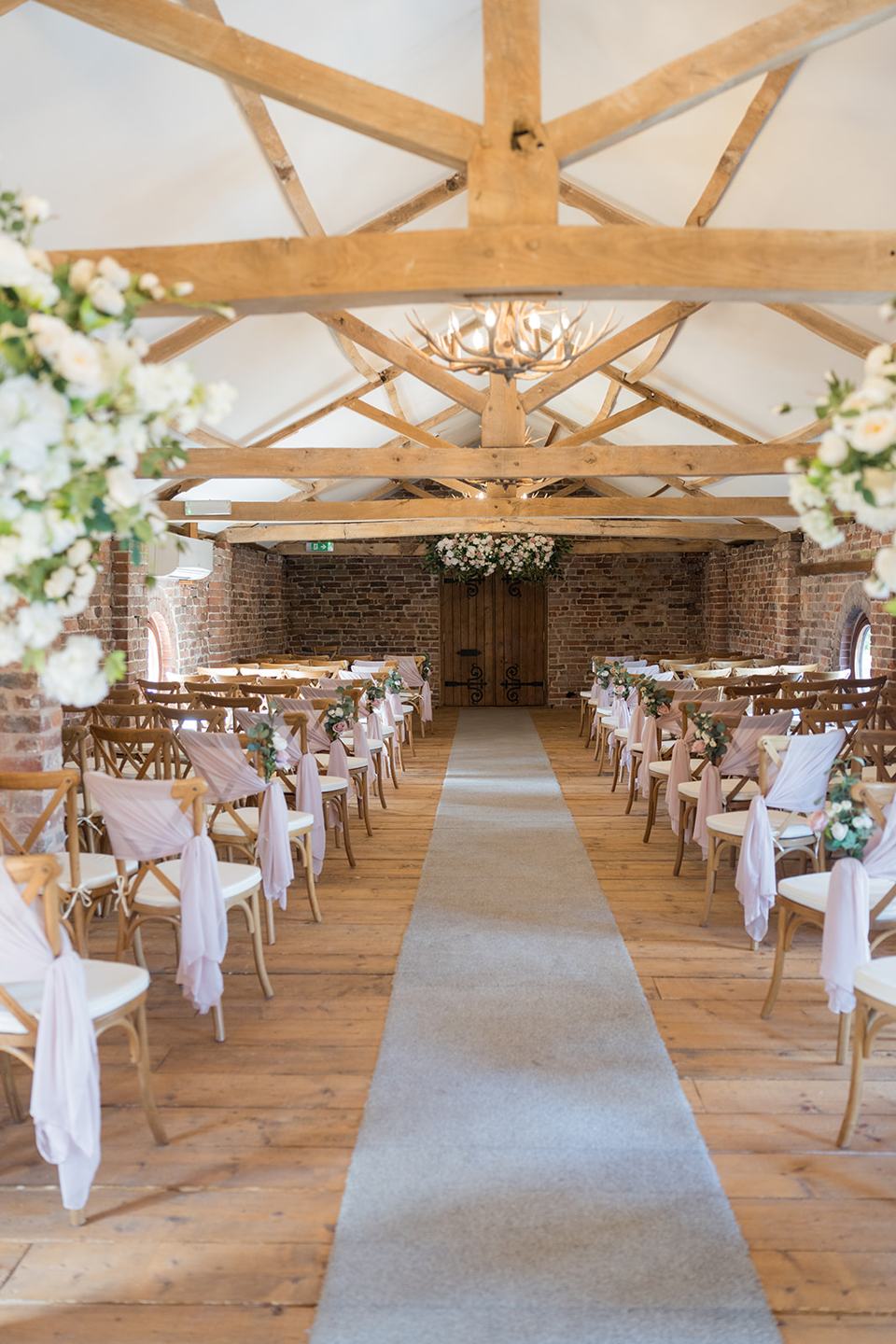 Ceremony room in the barn at Evie and Josh’s Burlton Manor wedding