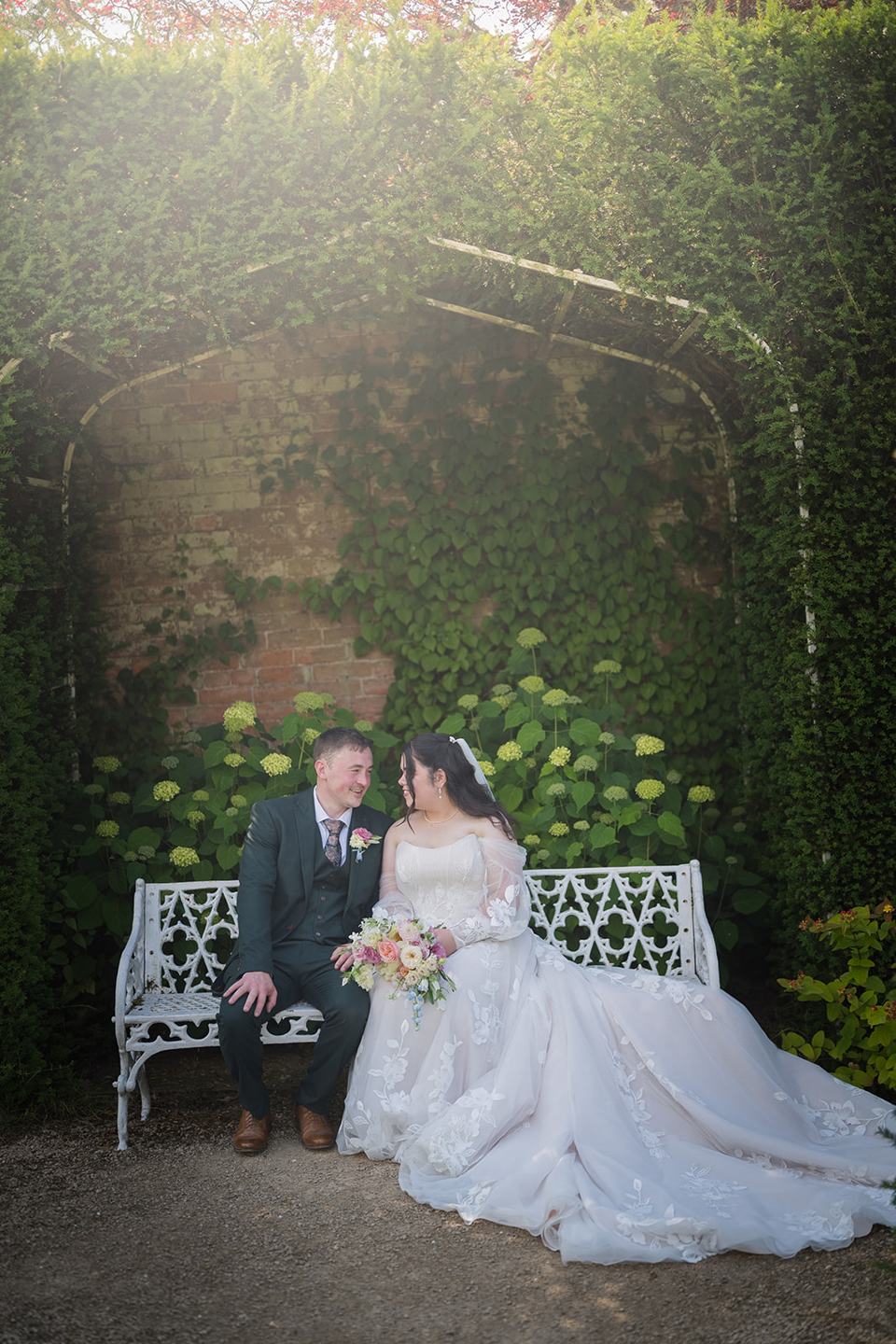 Portrait on the garden bench at Abi and Ben’s Combermere Abbey wedding