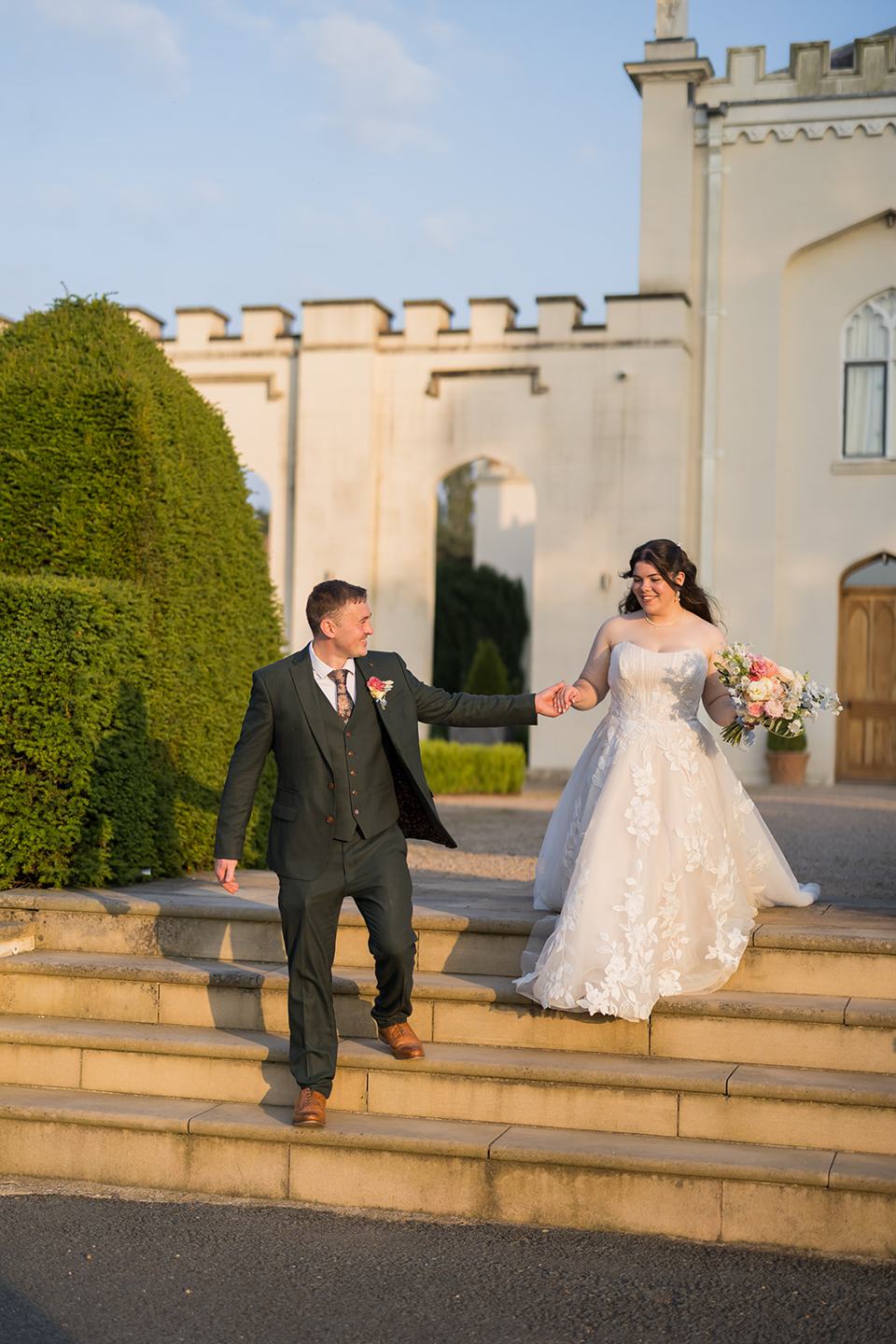 Newlyweds outside the Abbey at Abi and Ben’s Combermere Abbey wedding