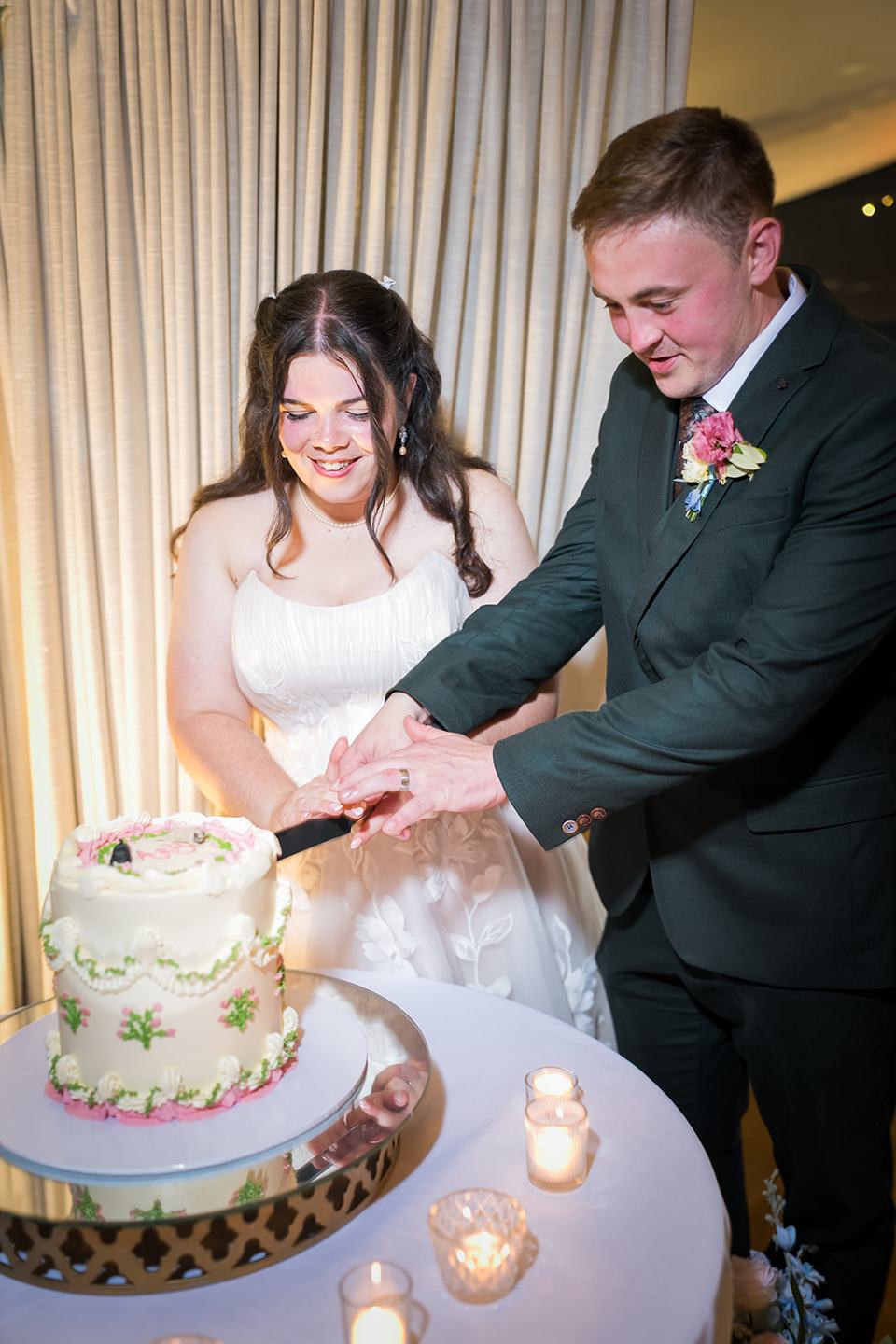Cutting the cake at Abi and Ben’s Combermere Abbey wedding