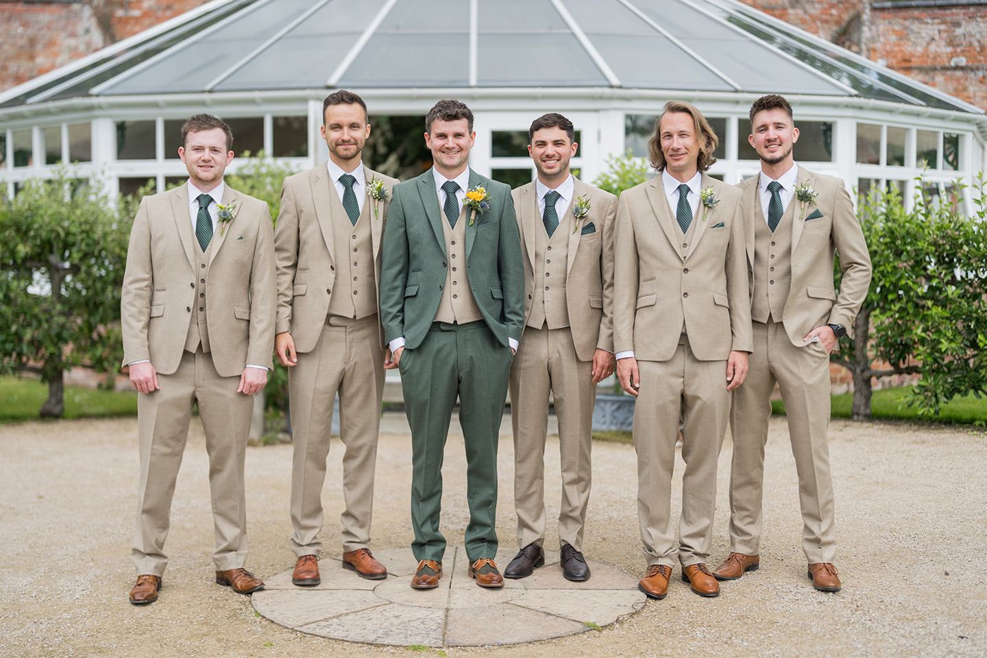 Groom and friends outside the glasshouse at Hannah and Jacob’s Combermere Abbey wedding
