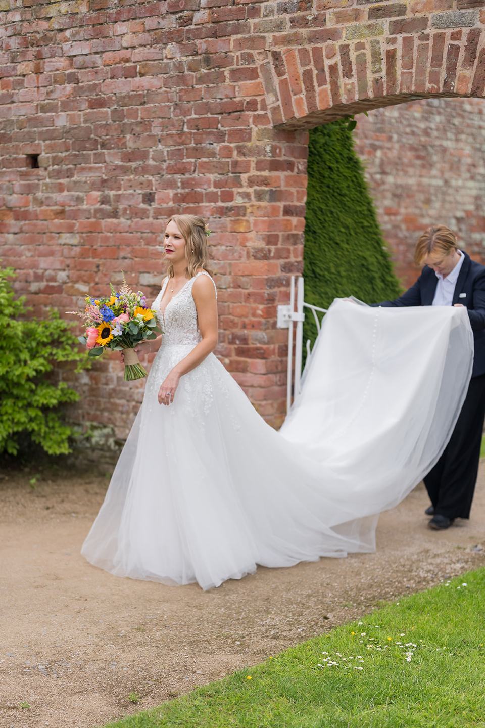 Bride entering the walled garden at Hannah and Jacob’s Combermere Abbey wedding
