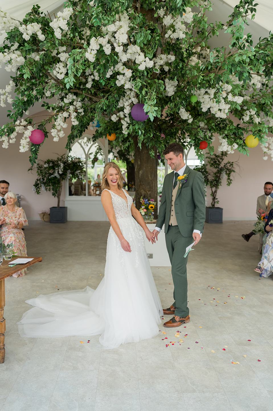 Ceremony beneath the floral canopy at Hannah and Jacob’s Combermere Abbey wedding