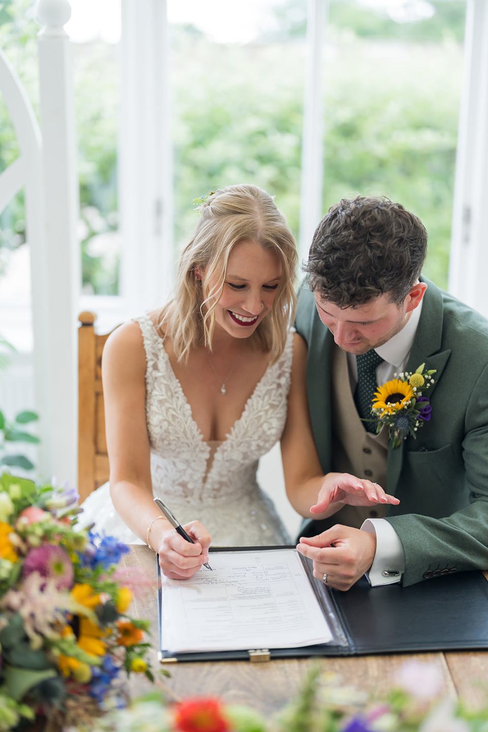 Signing the register at Hannah and Jacob’s Combermere Abbey wedding