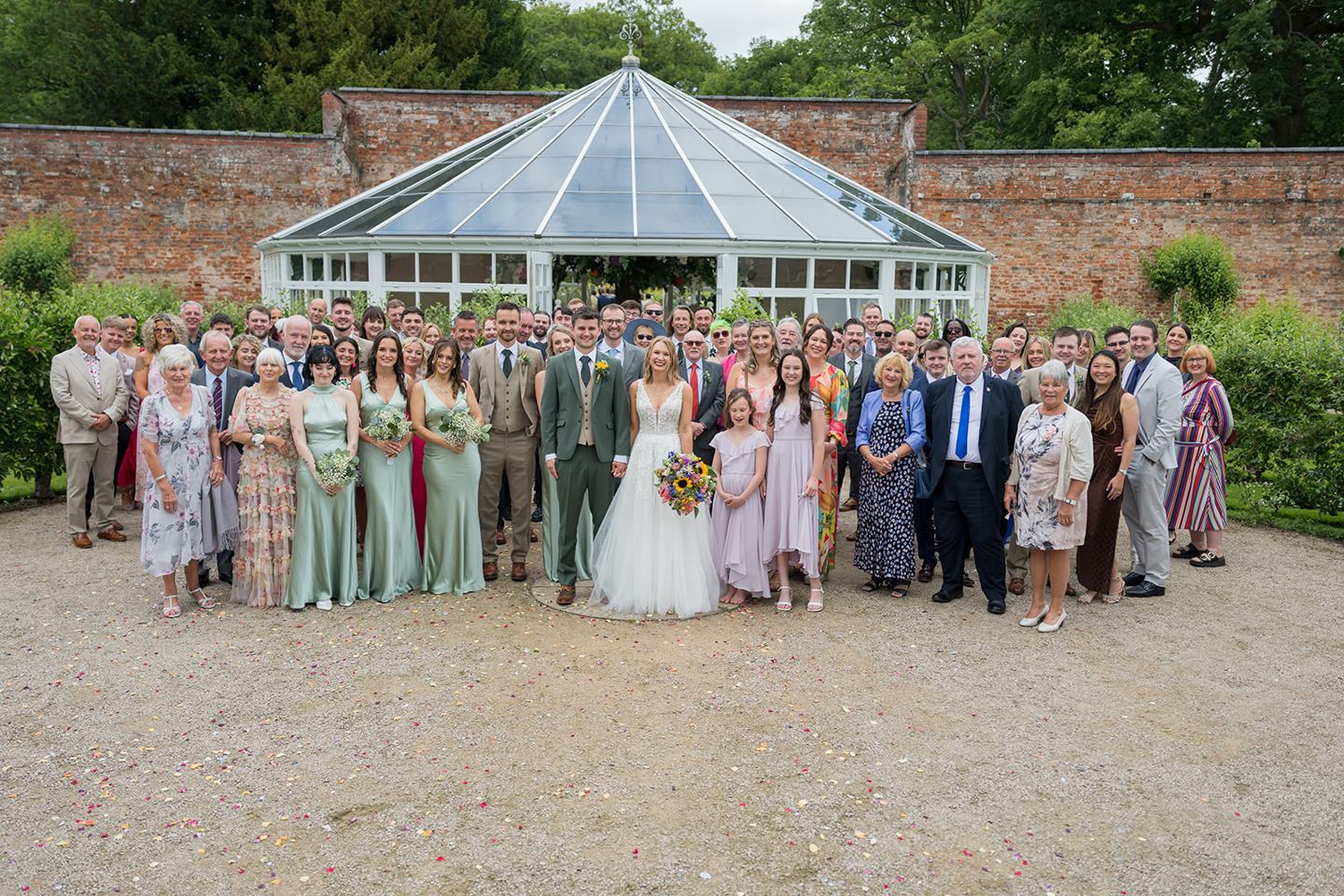 Wedding guests gathered in the gardens at Hannah and Jacob’s Combermere Abbey wedding