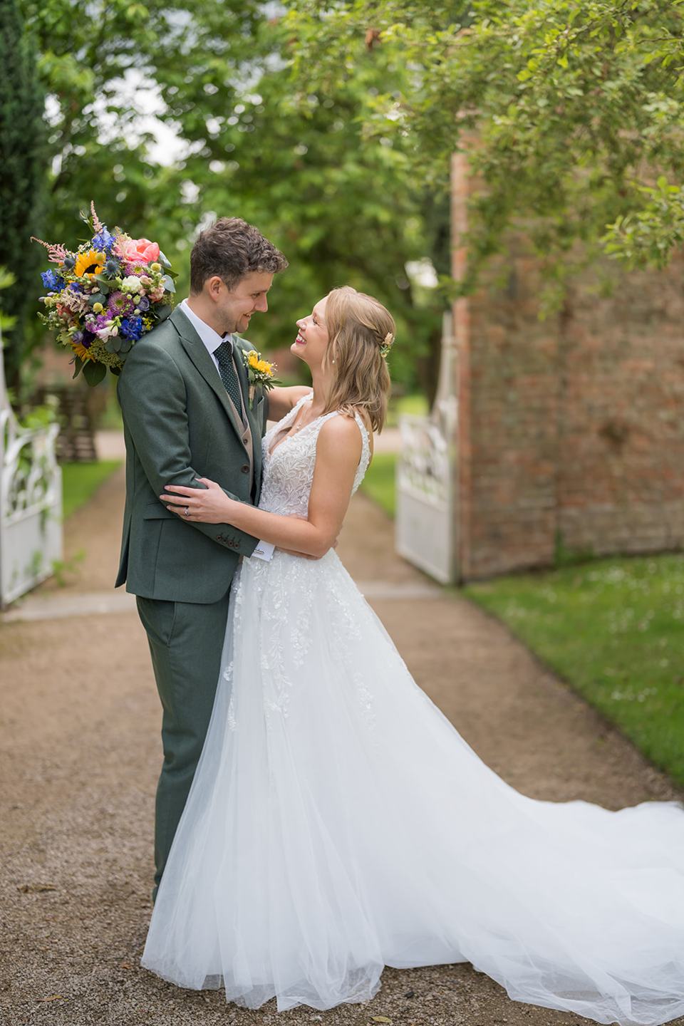 Couple portrait on the garden path at Hannah and Jacob’s Combermere Abbey wedding