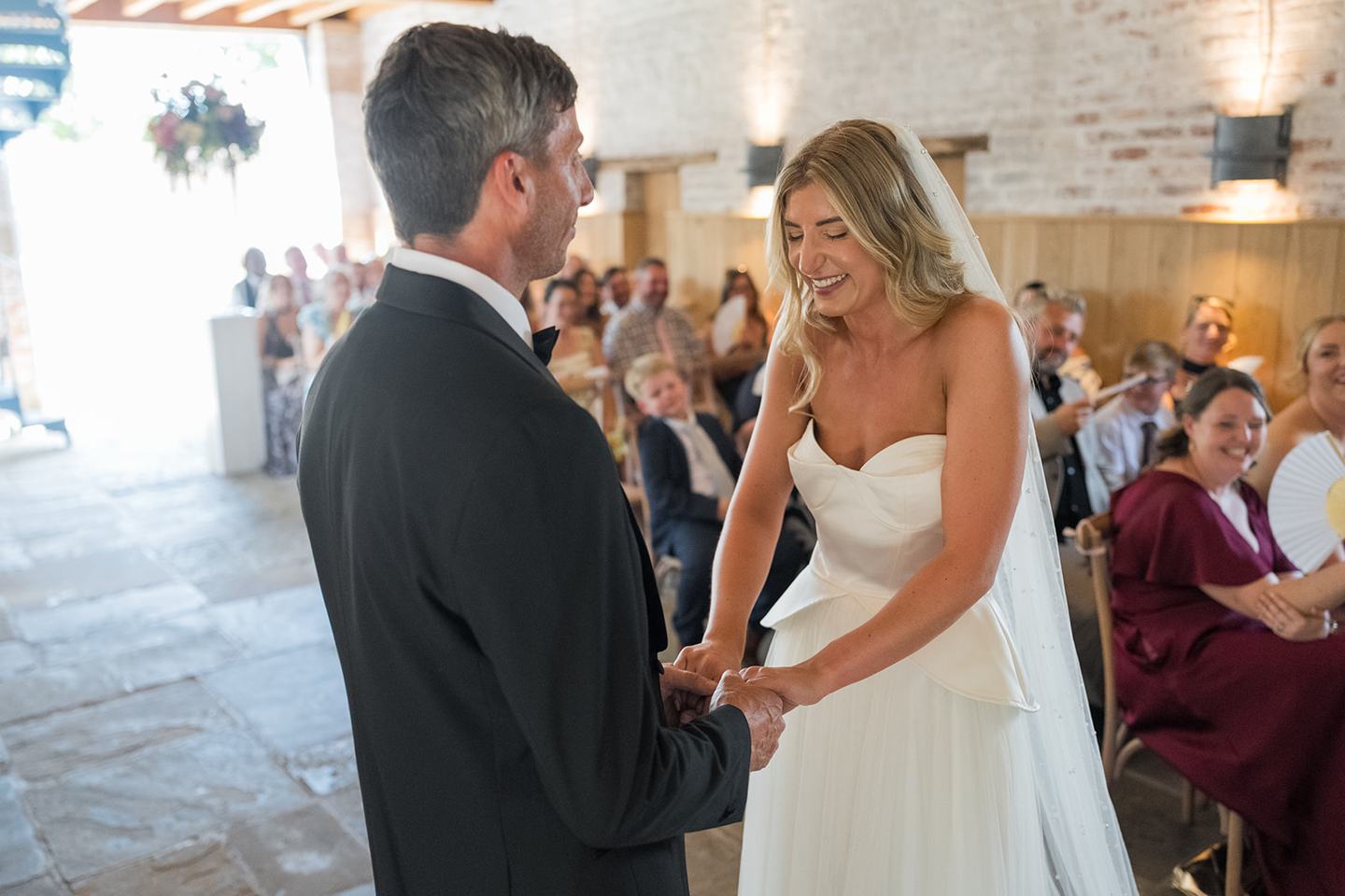 Exchanging rings at Lauren and Tom’s Dorfold Hall wedding