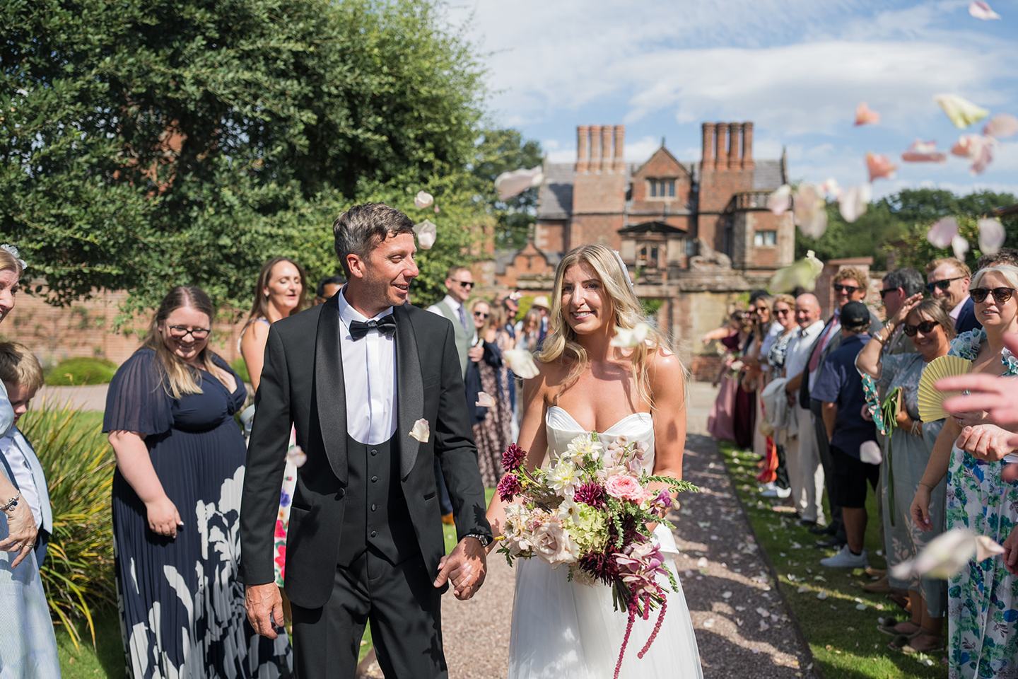 Confetti outside the hall at Lauren and Tom’s Dorfold Hall wedding