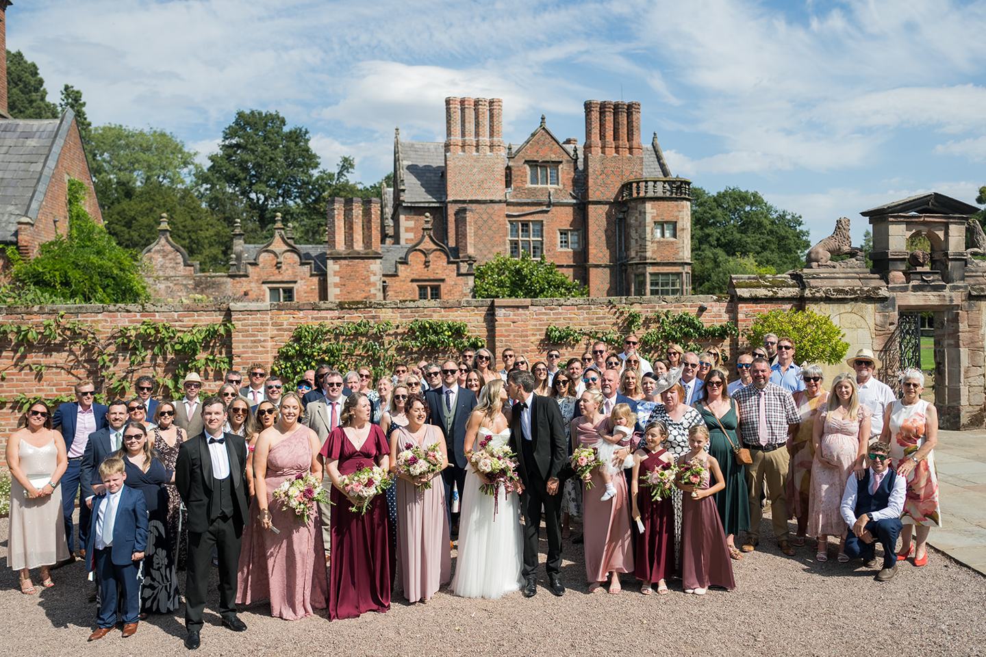 Guests gathered on the lawn at Lauren and Tom’s Dorfold Hall wedding