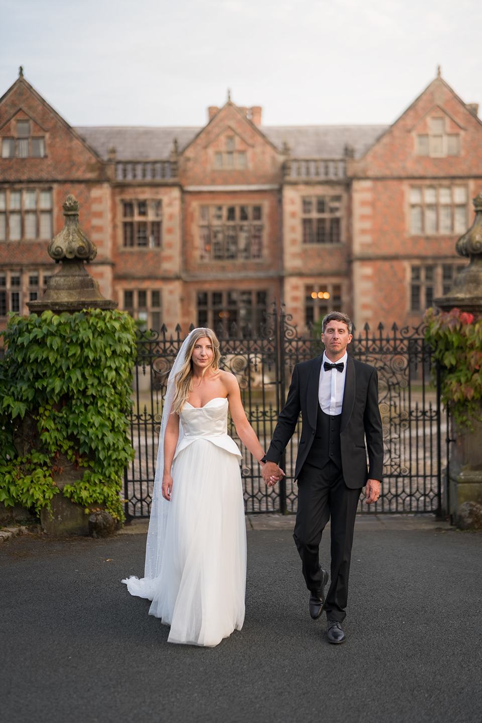 A portrait in front of the hall at Lauren and Tom’s Dorfold Hall wedding