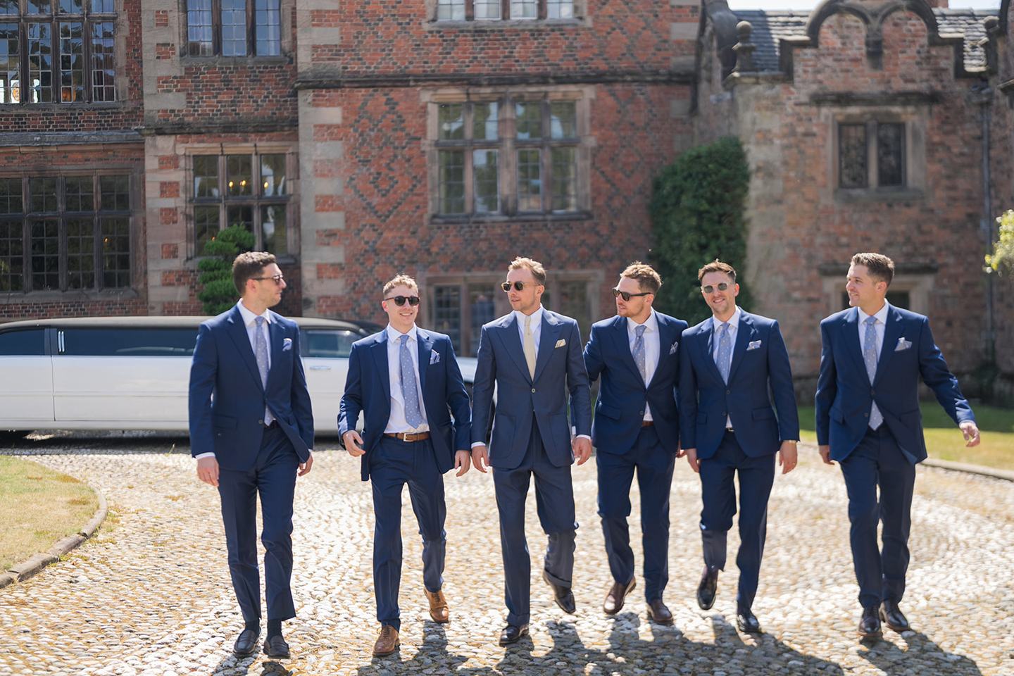 Groomsmen outside the hall at Lizzie and Jack’s Dorfold Hall wedding