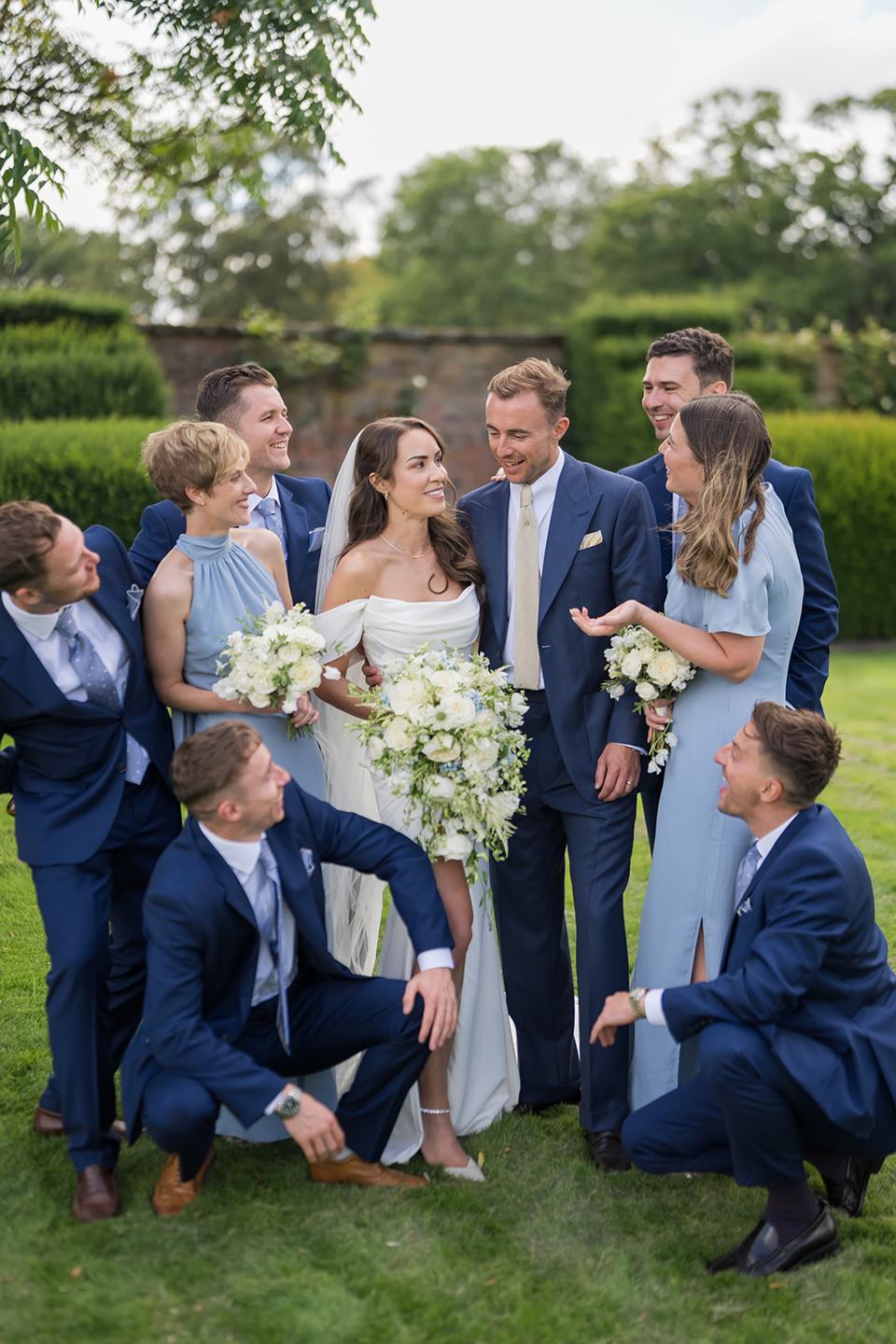 Wedding party enjoying the gardens at Lizzie and Jack’s Dorfold Hall wedding