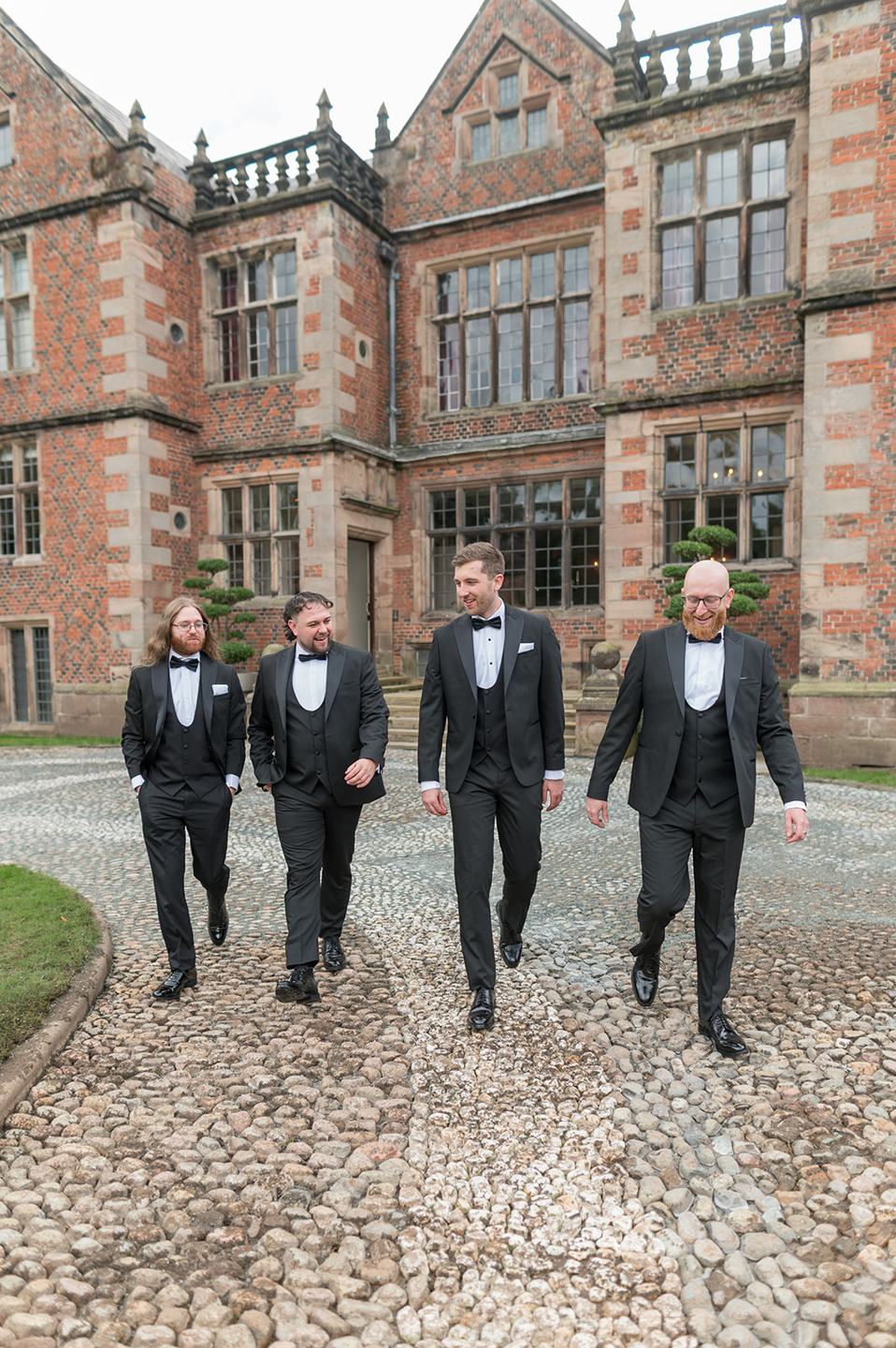 Groomsmen outside the hall at Louise and Ben’s Dorfold Hall wedding